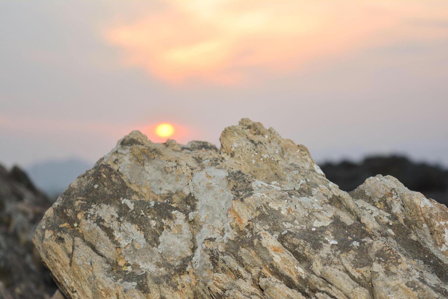 Rock Formation at Sunset with Golden Sky Background photo