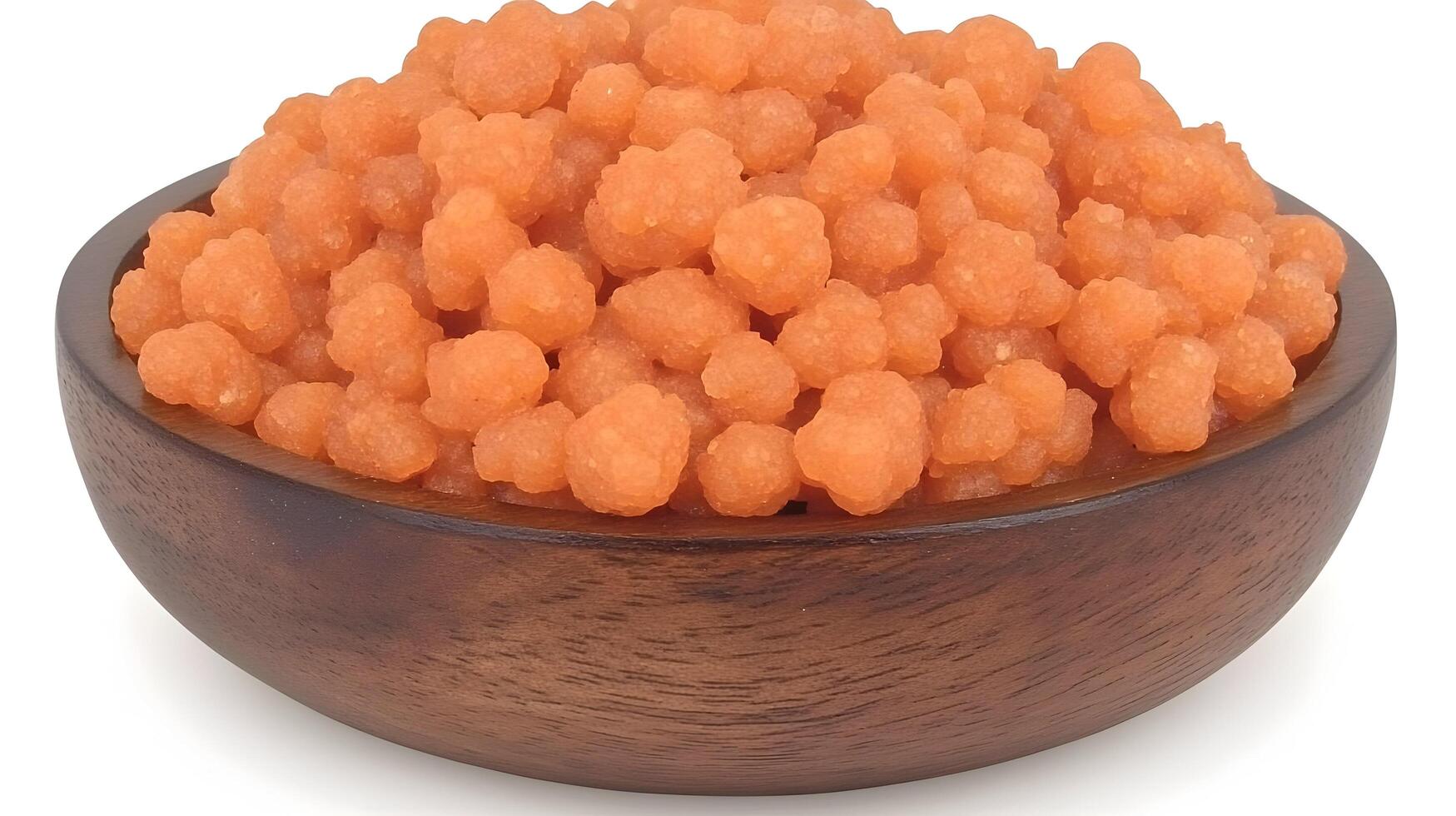A bowl of vibrant orange, small, round, sweet treats, perfect for sharing or a special occasion, nestled in a rich, dark wood bowl. photo