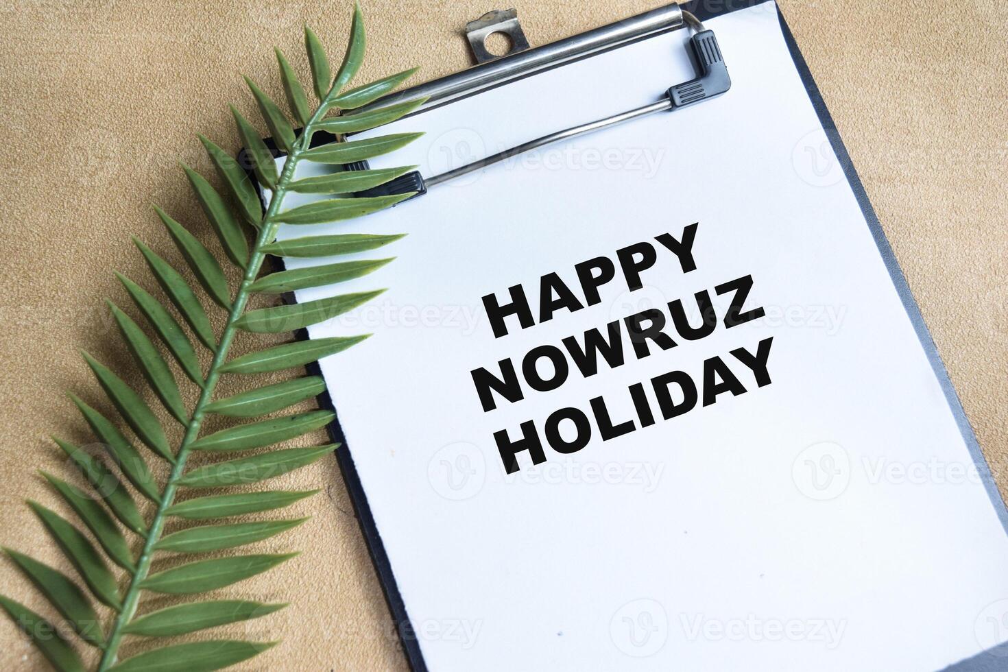 Concept of Happy Nowruz Holiday write on paperwork isolated on Wooden Table. photo