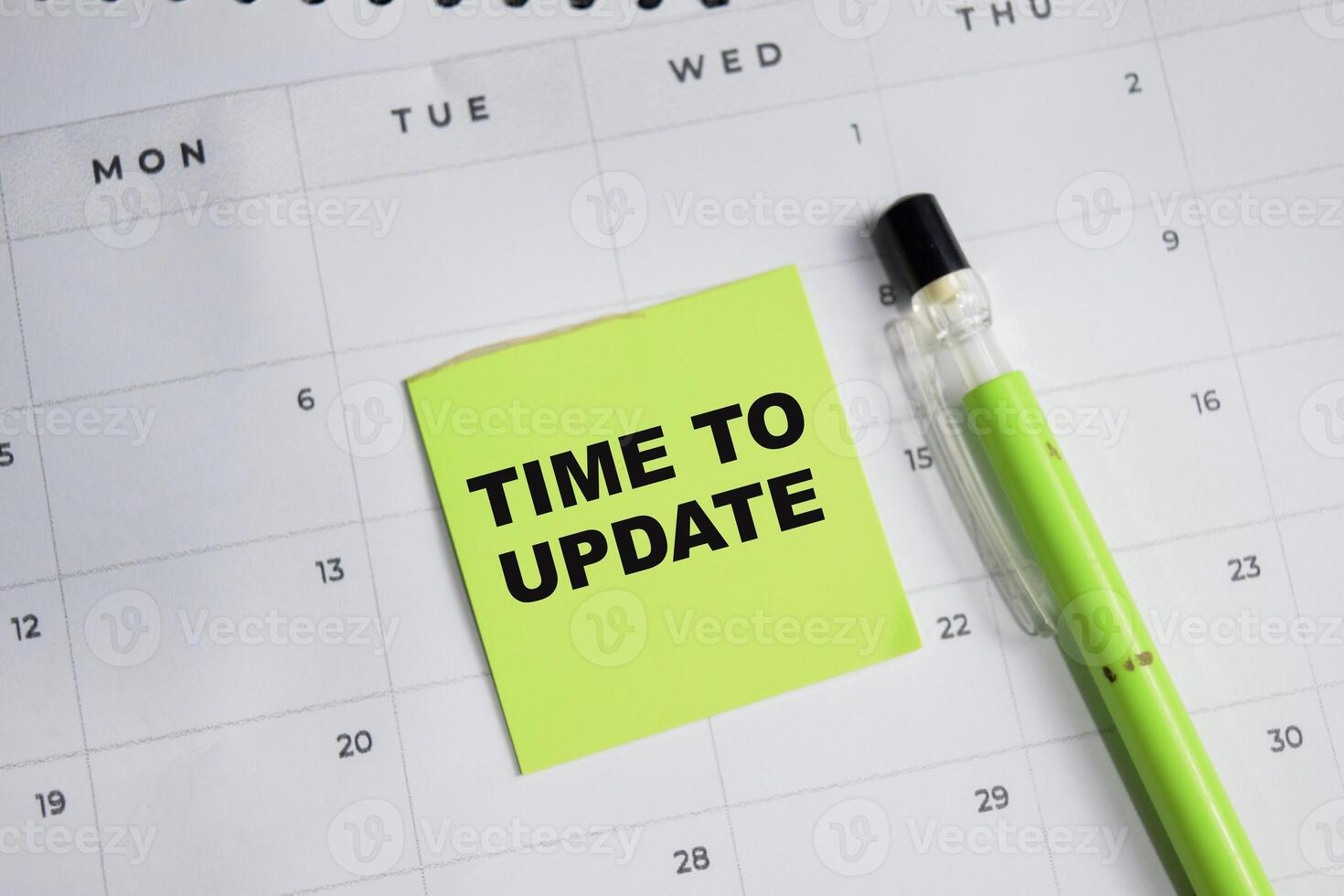 Concept of Time to Update write on sticky notes and calendar isolated on Wooden Table. photo
