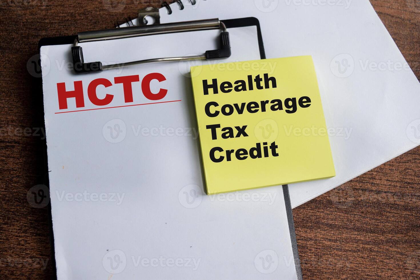 Concept of HCTC - Health Coverage Tas Credit write on sticky notes isolated on Wooden Table. photo