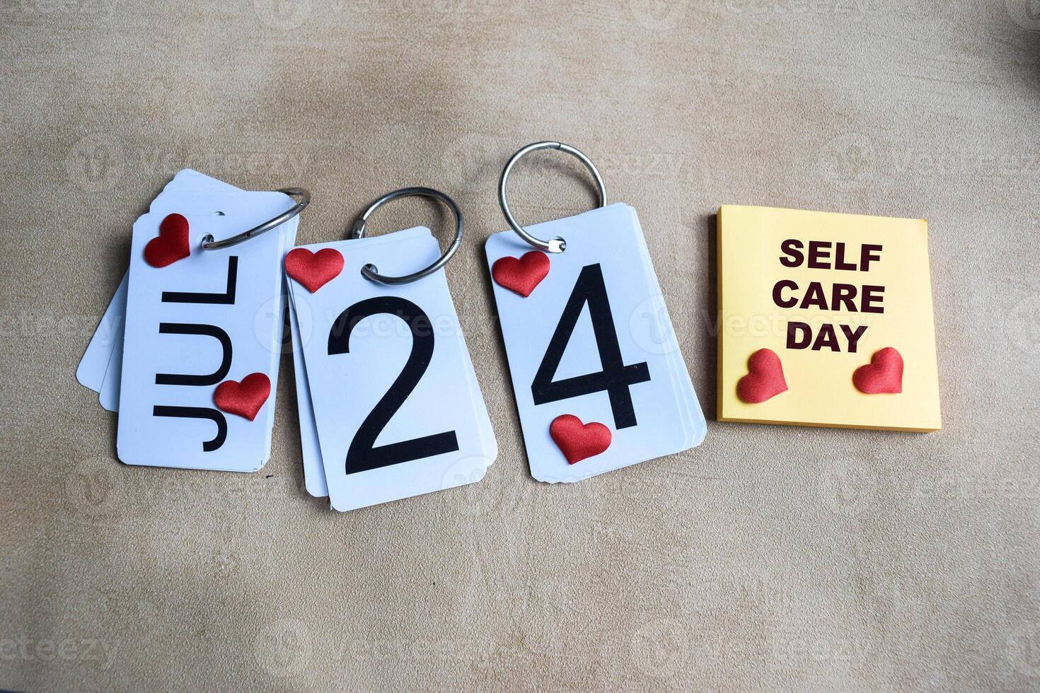 Date 24th of July on the calendar. Self care day on the table background photo