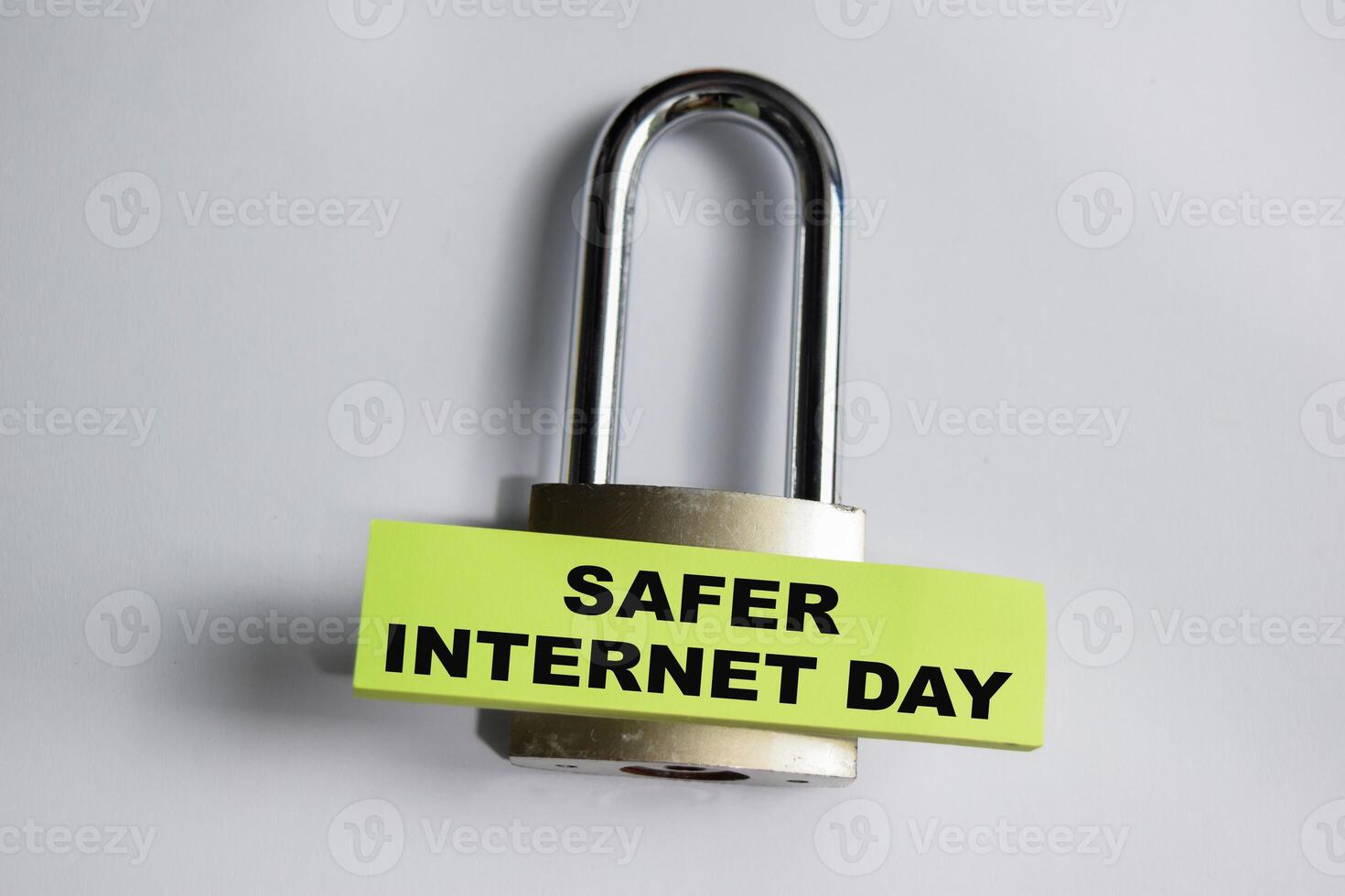 Concept of Safer Internet day write on sticky notes and padlock isolated on Wooden Table. photo