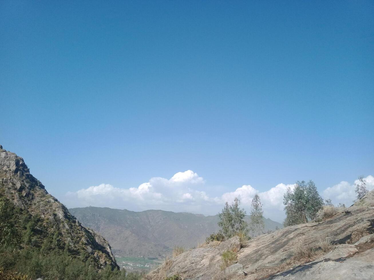 Majestic Mountain Landscape with Clear Blue Sky and Rolling Clouds. photo
