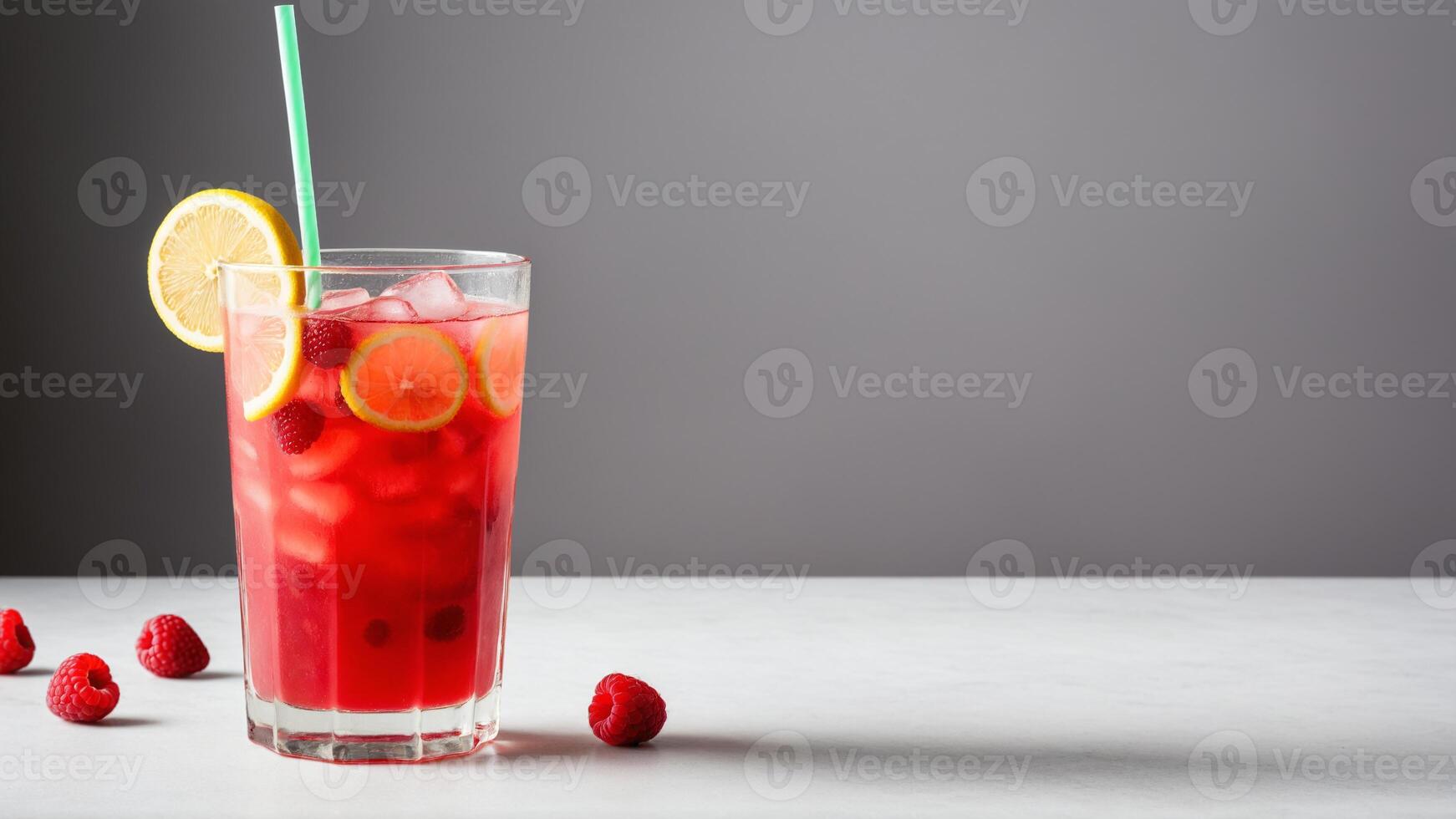 A glass of raspberry lemonade with a straw photo