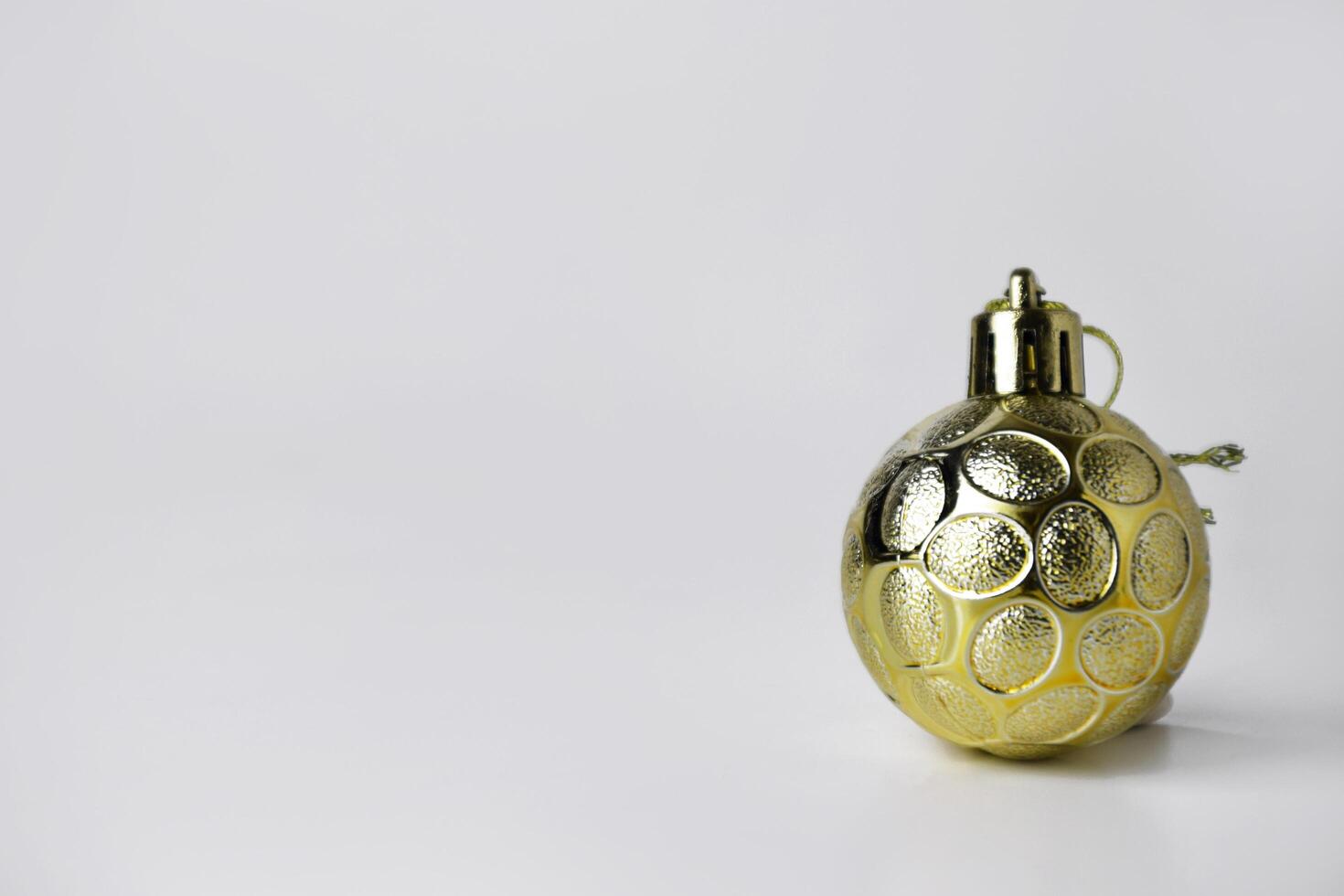 Festive Gold Christmas Ball with White Background photo
