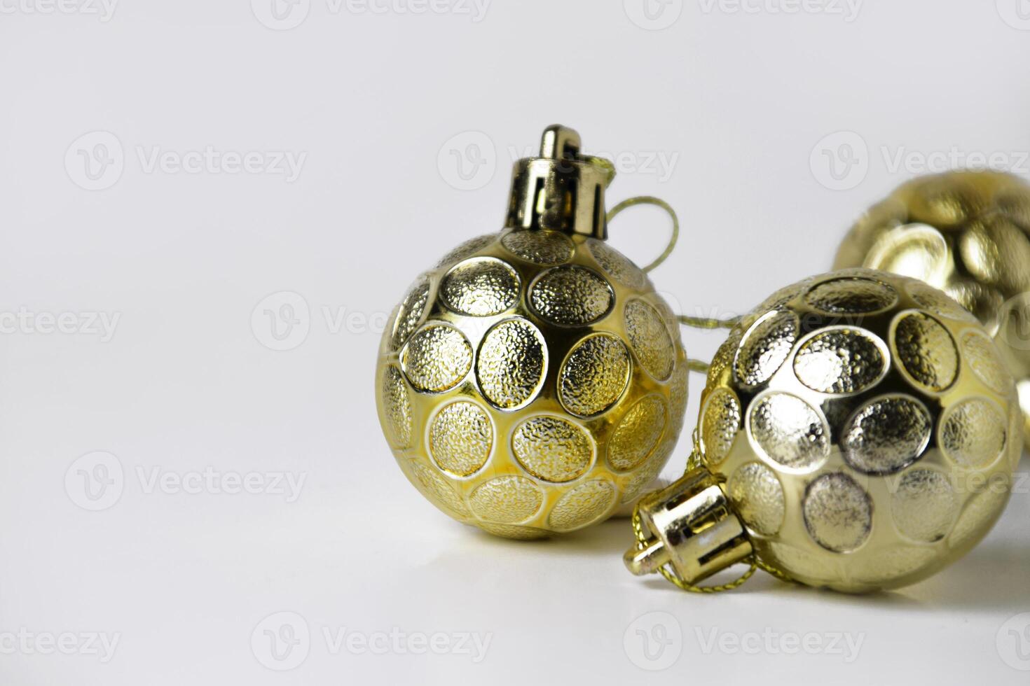 Closeup of three gold Christmas ball ornaments with textured designs photo