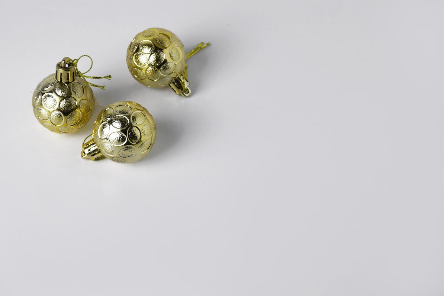 Top view of three gold Christmas ball ornaments with textured designs photo
