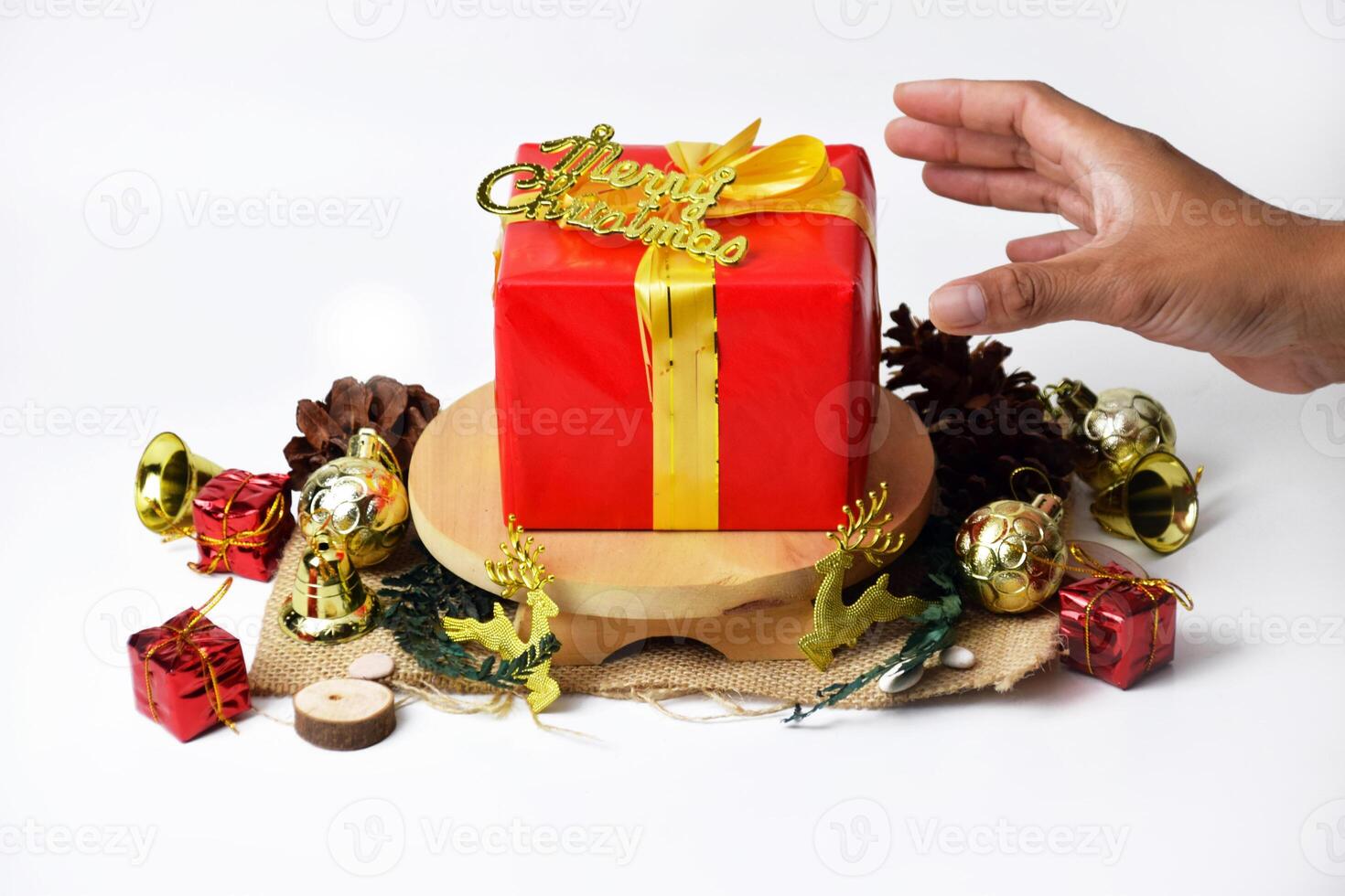 Red christmas present with gold ribbon on wood surface photo