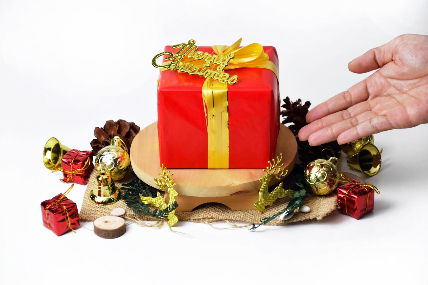 Vibrant Red Xmas Box Tied with Golden Ribbon and Merry Christmas Words photo