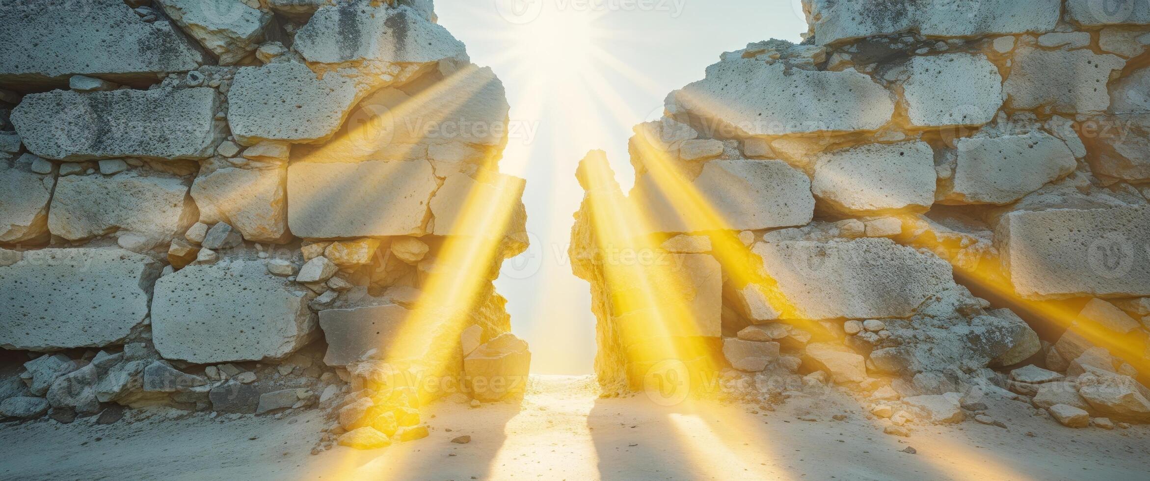 The sun shining through a stone wall photo