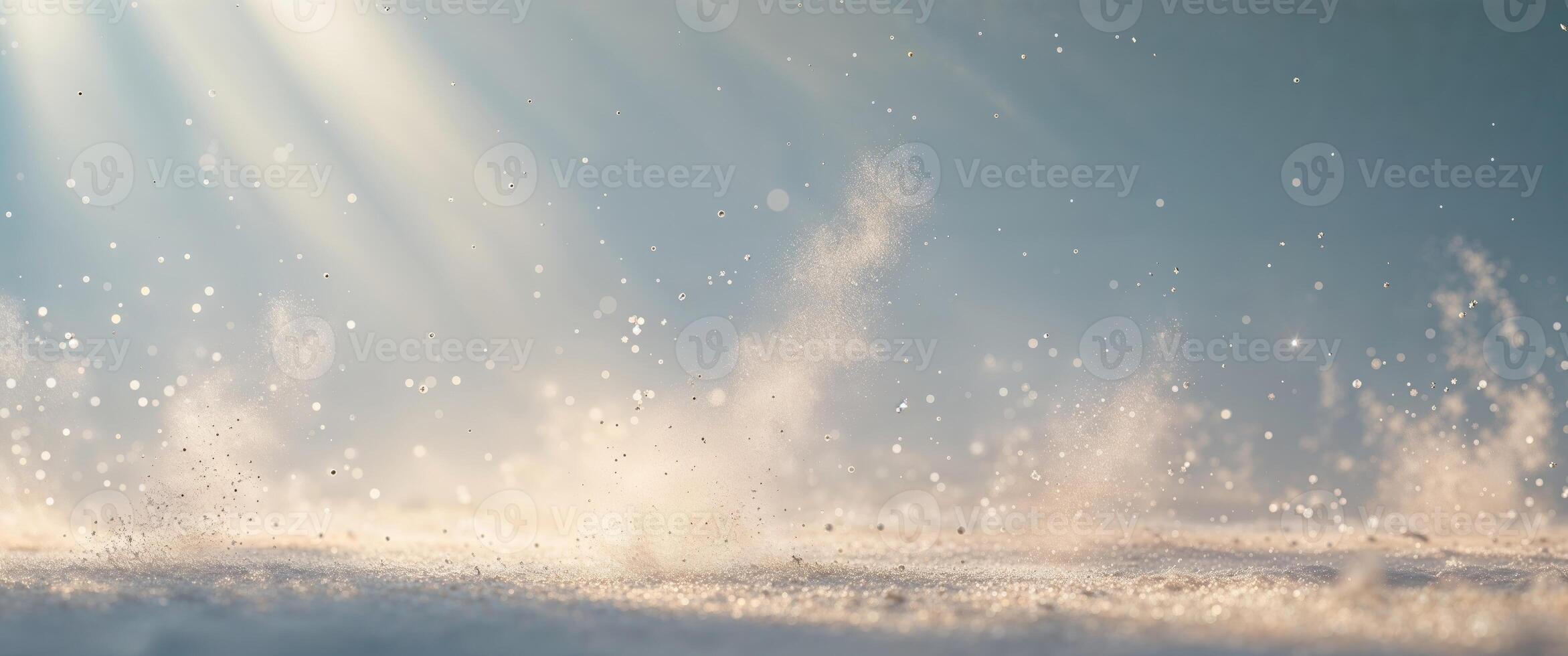 Snow falling on the ground with sun rays shining through photo