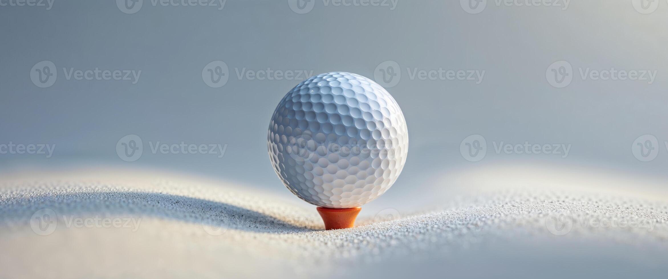 Ready for the swing a closeup of a golf ball on a tee. photo