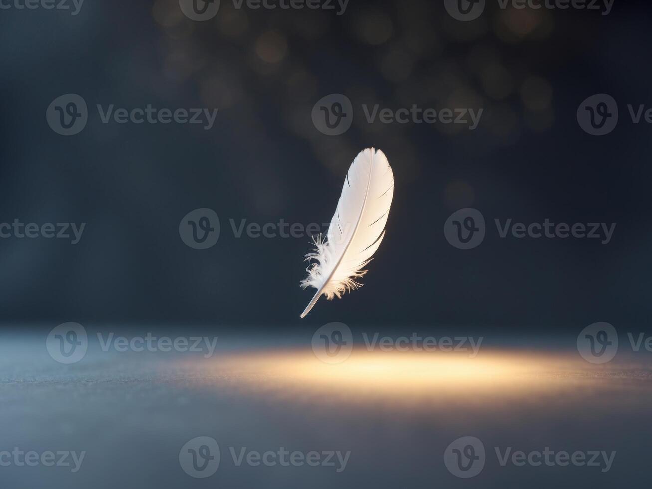 A feather floating in the air on a dark surface photo