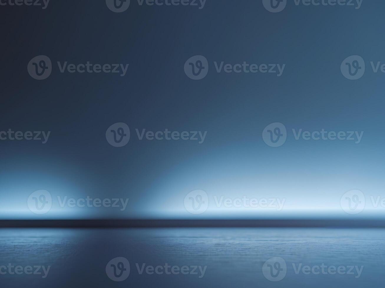 An empty room with a dark floor and a light photo