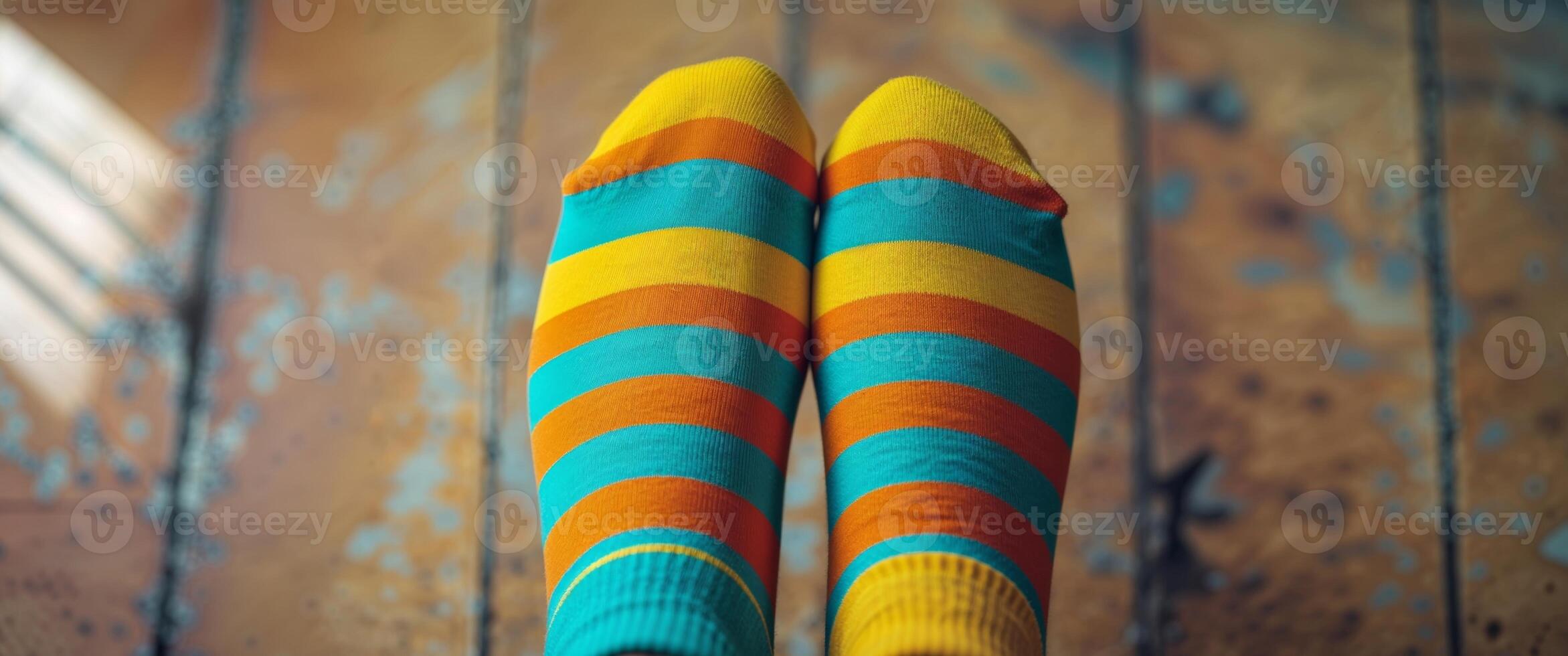 A person wearing colorful socks on a wooden floor photo