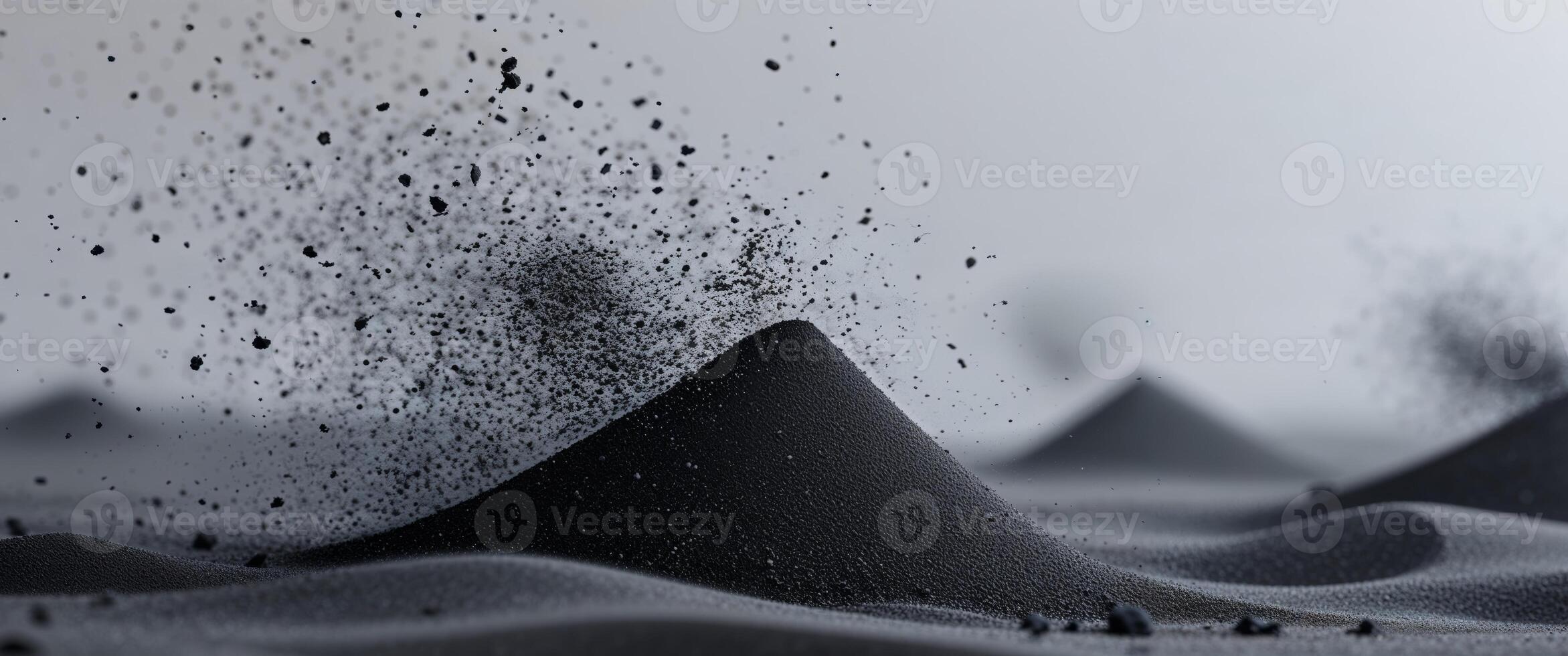 A black mountain with sand and water photo