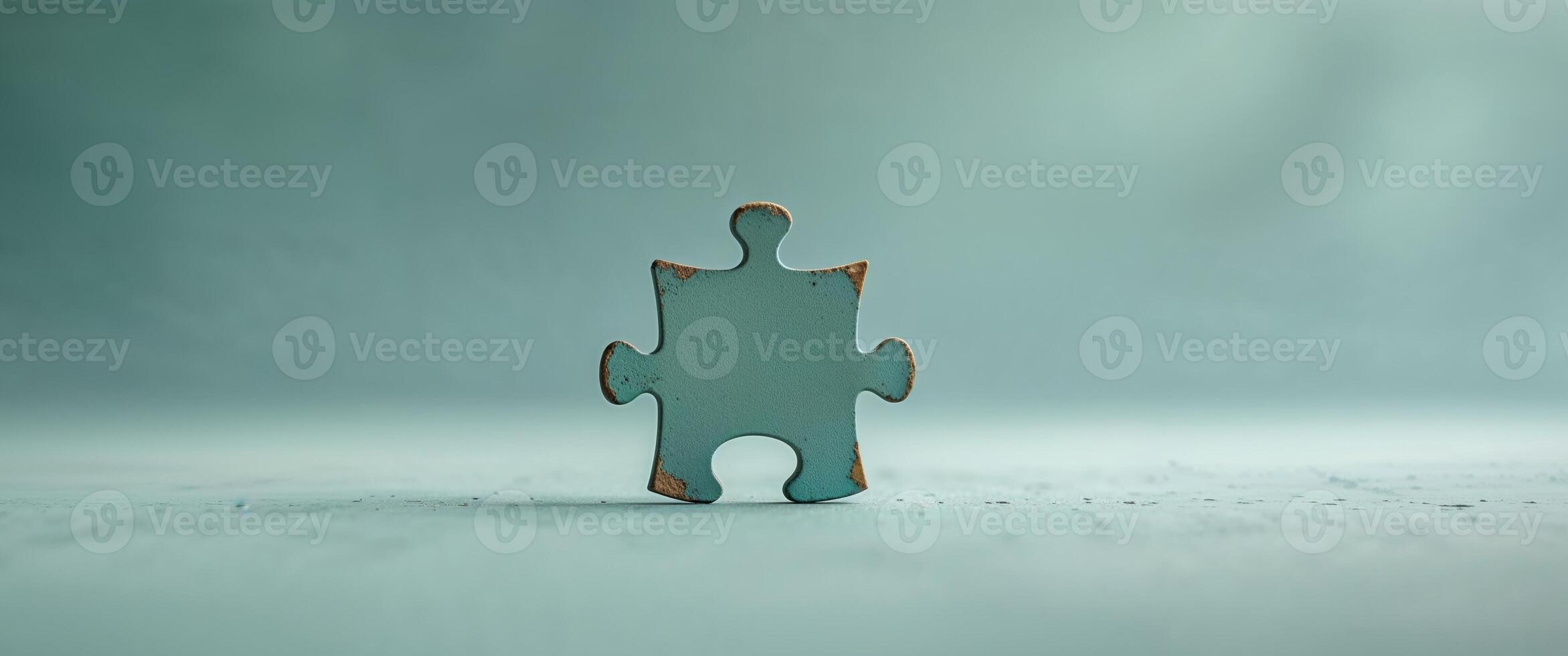 Completing a puzzle piece on a teal background photo