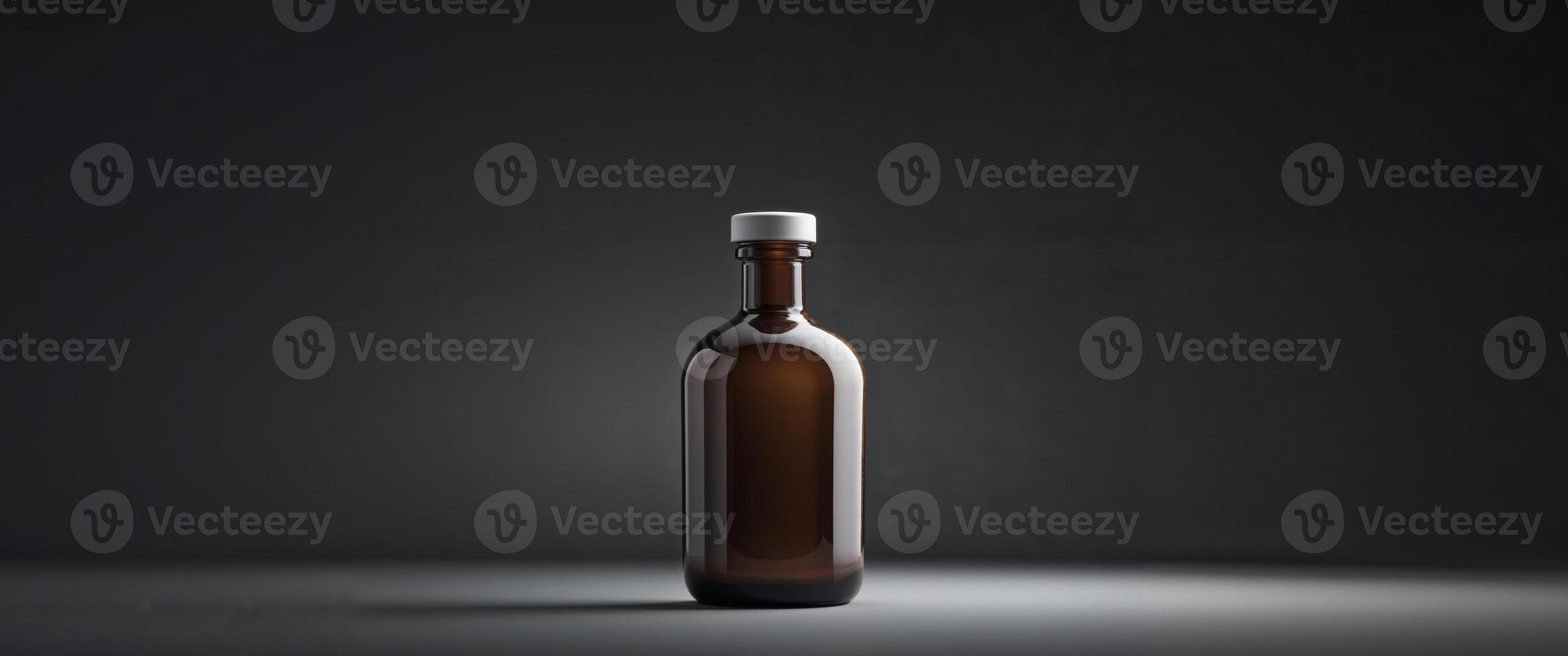 Brown glass bottle with white cap on dark background for packaging photo