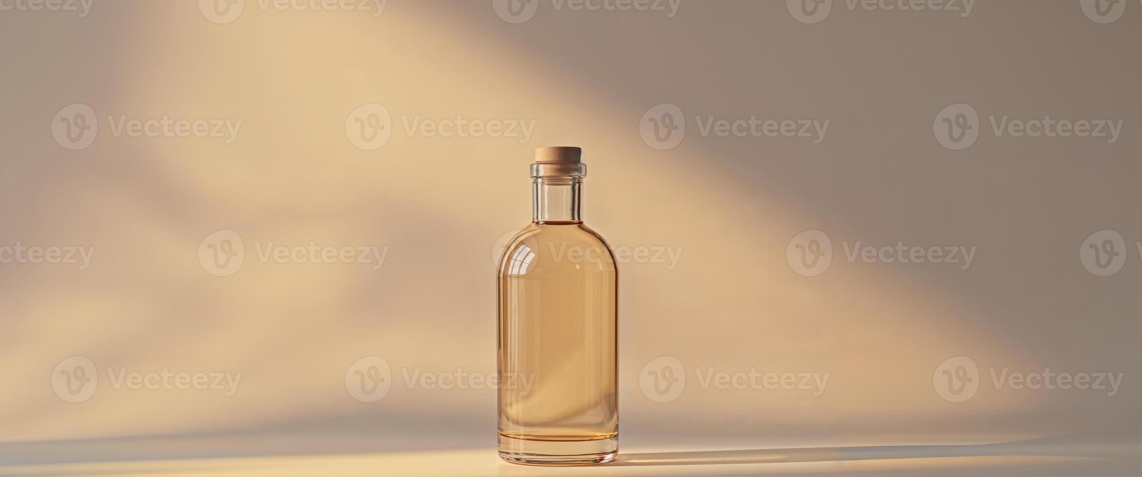 Glass bottle with liquid on a warm background. photo
