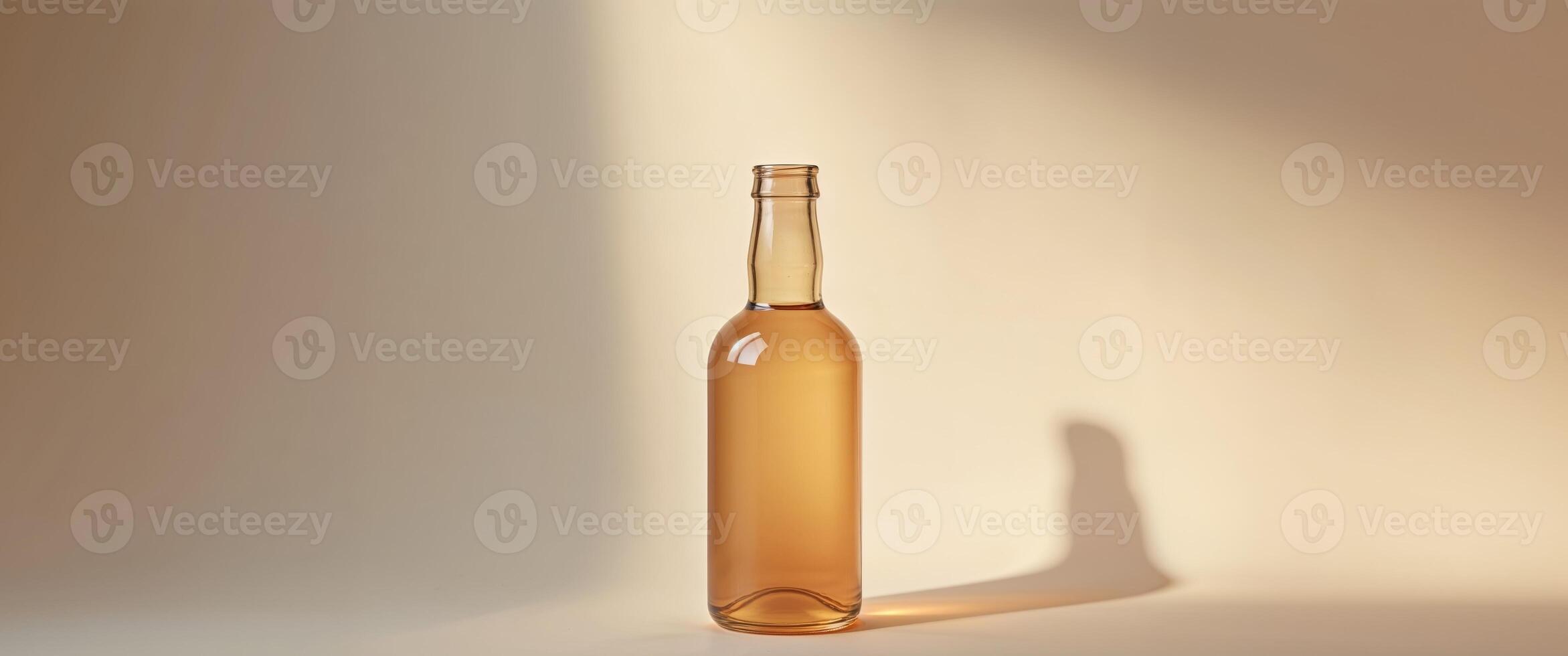 Glass bottle with liquid on a warm background photo