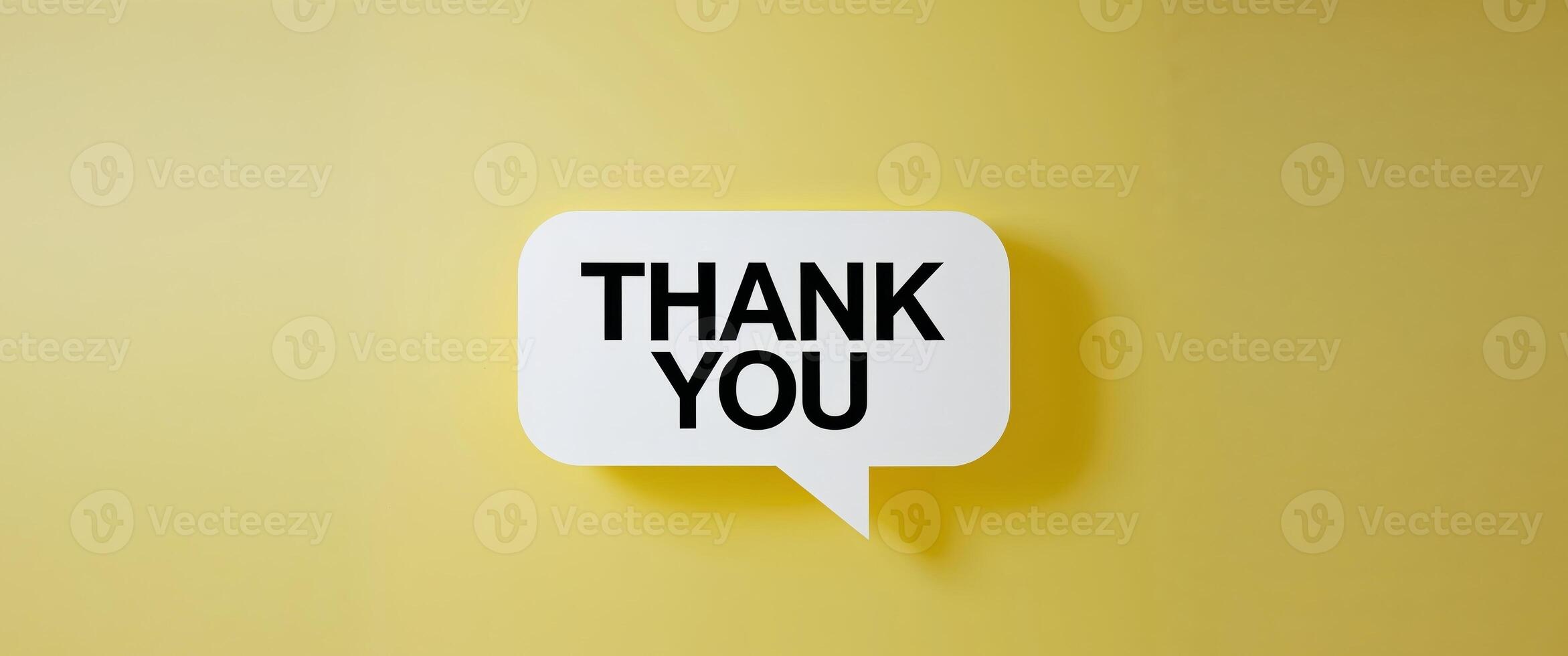 Bright yellow background with a speech bubble expressing gratitude in bold letters captures a joyful and positive message of appreciation. photo