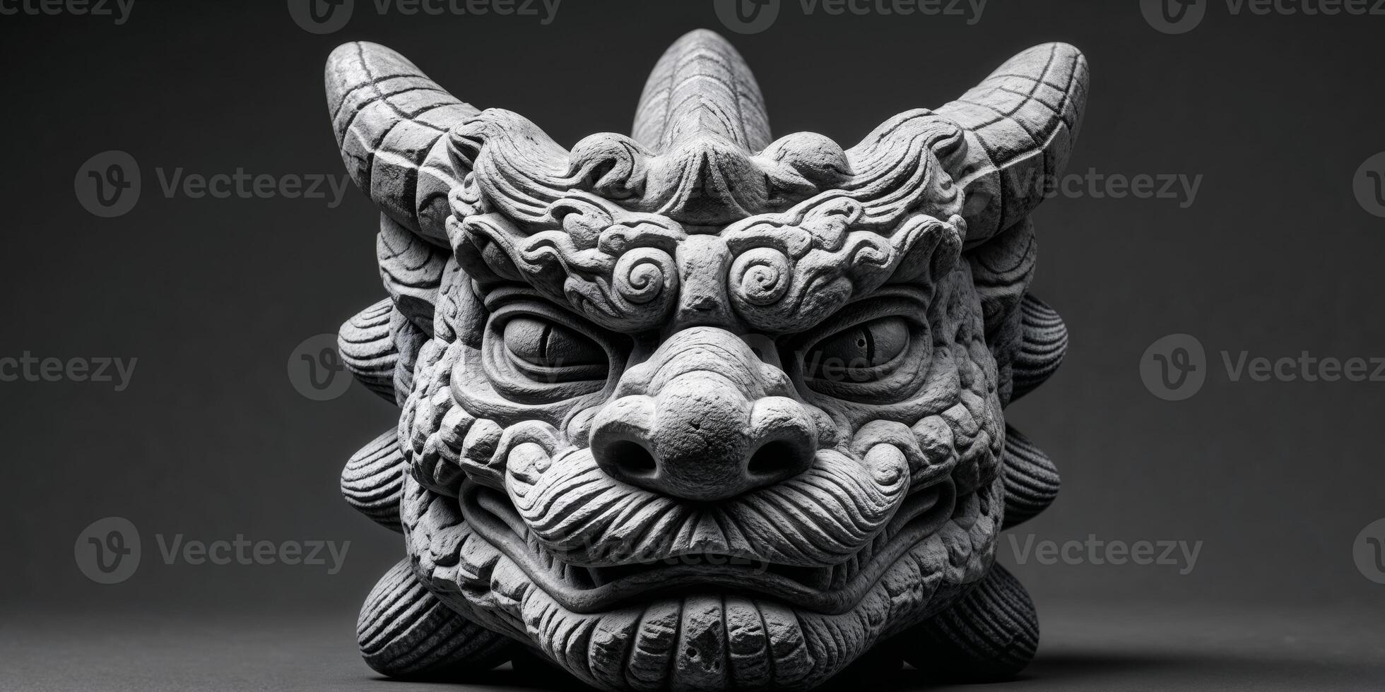 A statue of a dragon head on a black background photo