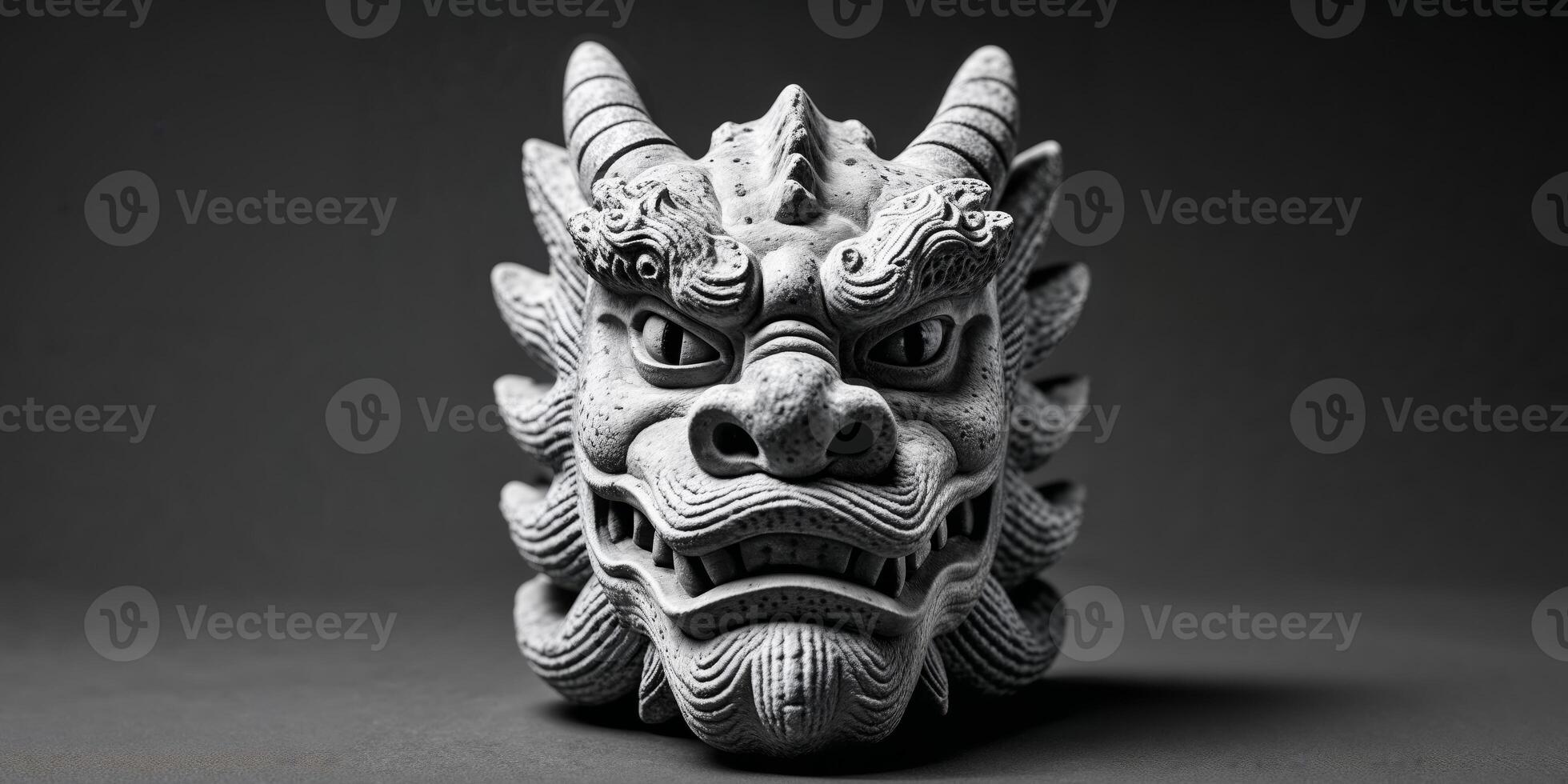 Textured stone carving resembling a dragon head with eyes. photo
