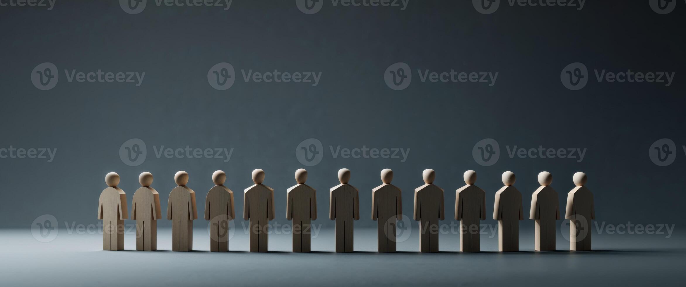A group of wooden people standing in a line photo
