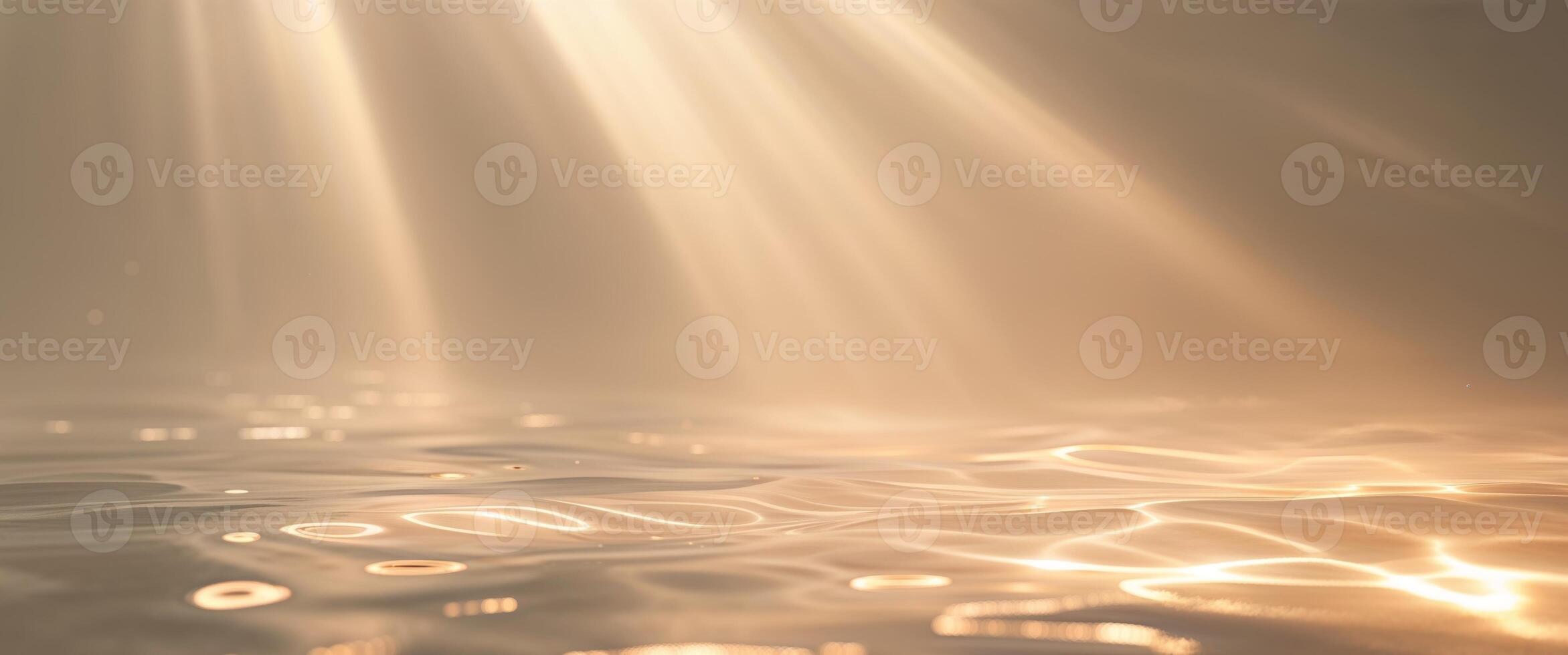 Sunbeams shining through water on a surface photo