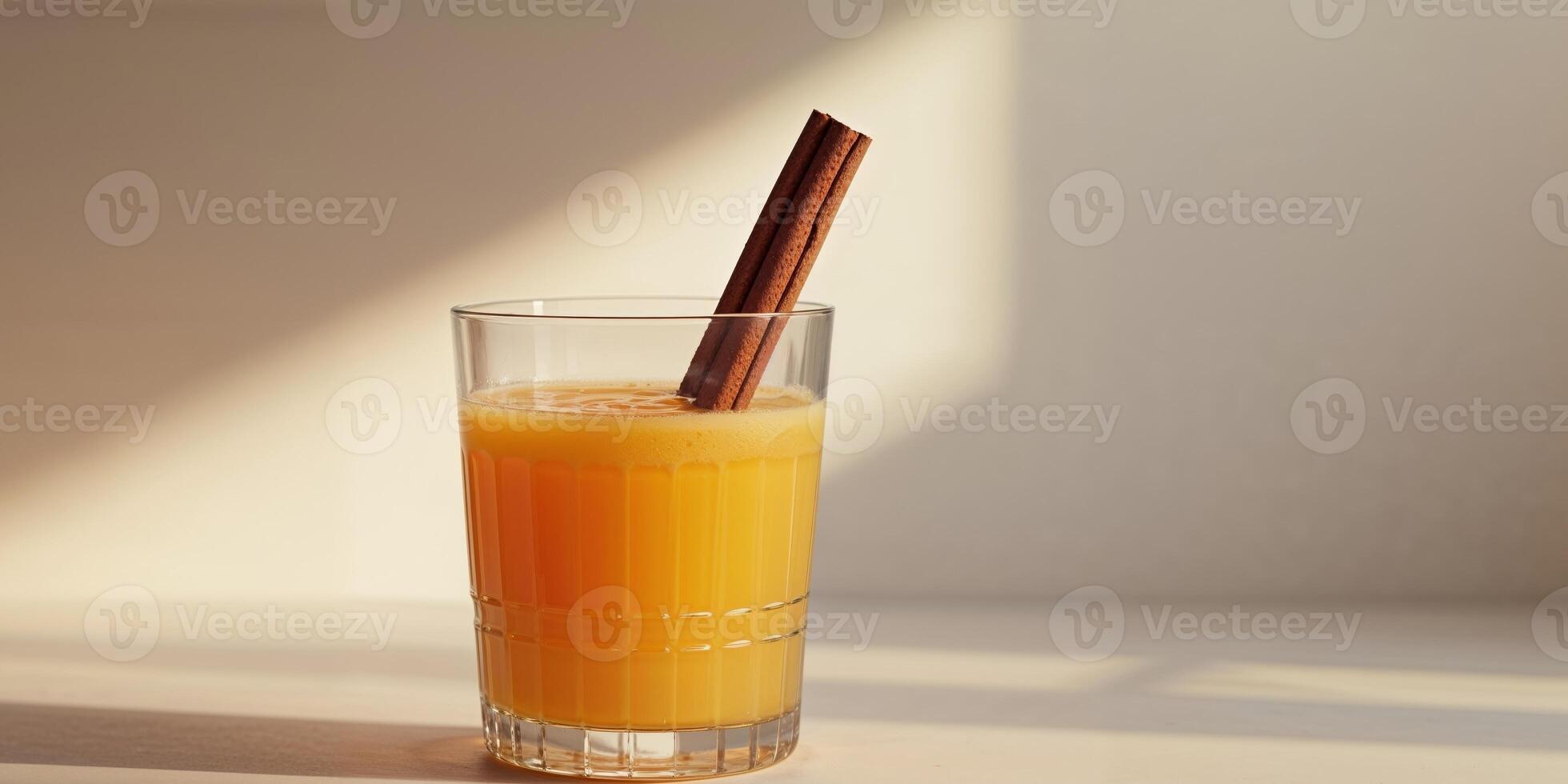 Refreshing Glass of Orange Juice Garnished with Cinnamon Stick for Flavor. photo