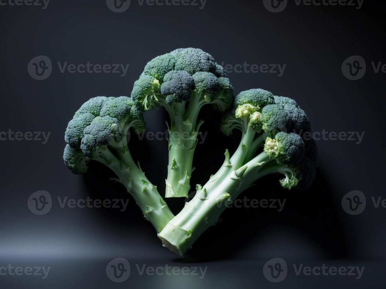 Three pieces broccoli black background is arranged triangular. photo