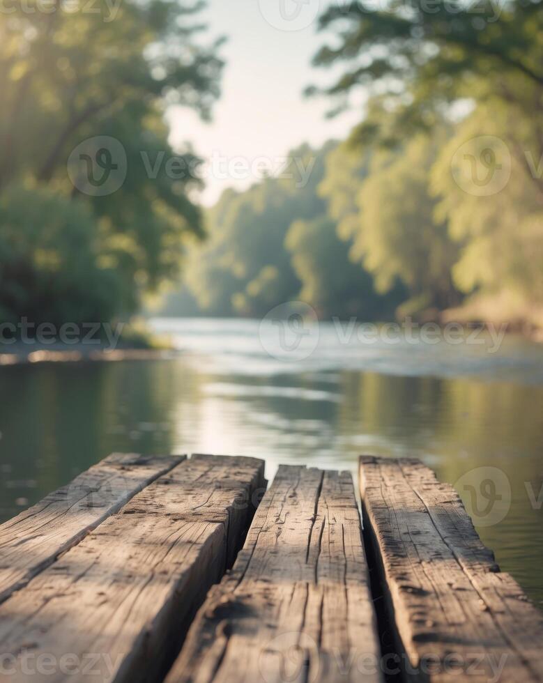 A wooden dock on the river with trees in the background photo