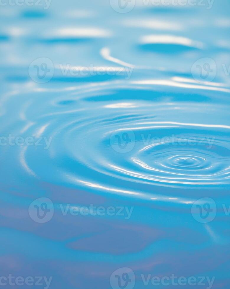 A blue water surface with ripples and a circular pattern photo