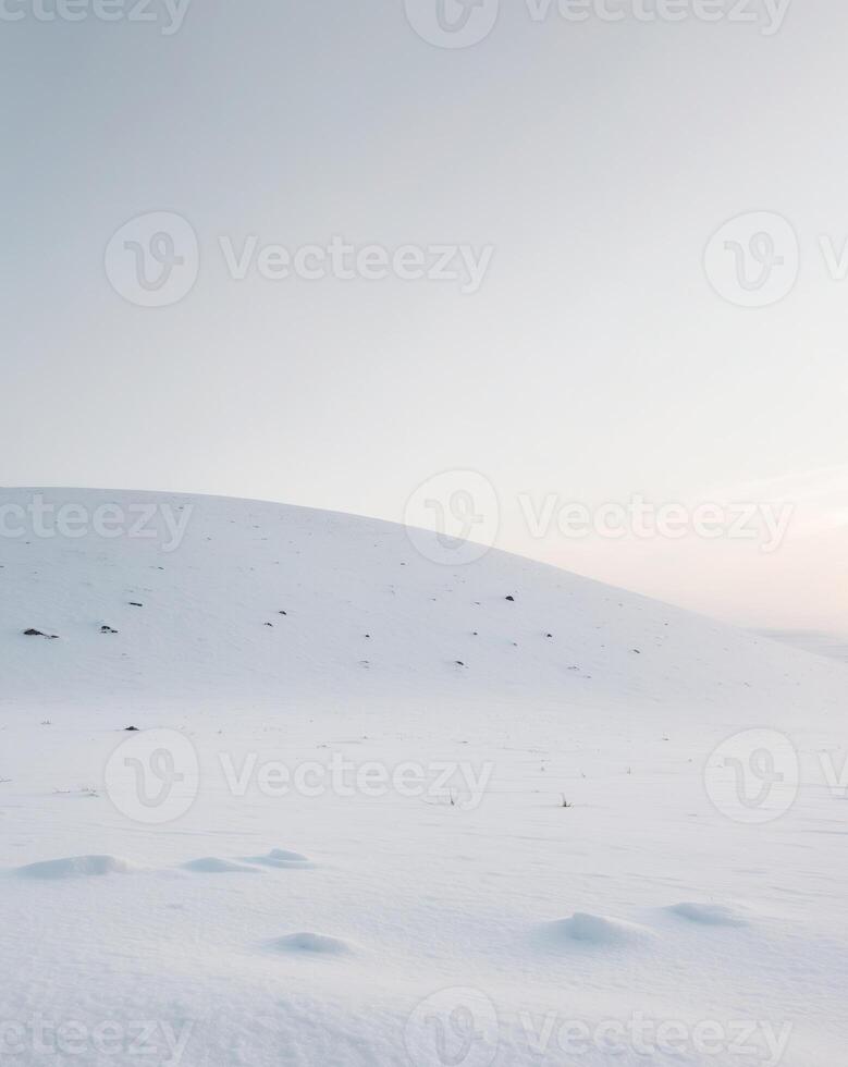 A lone person walking across a snowy field photo