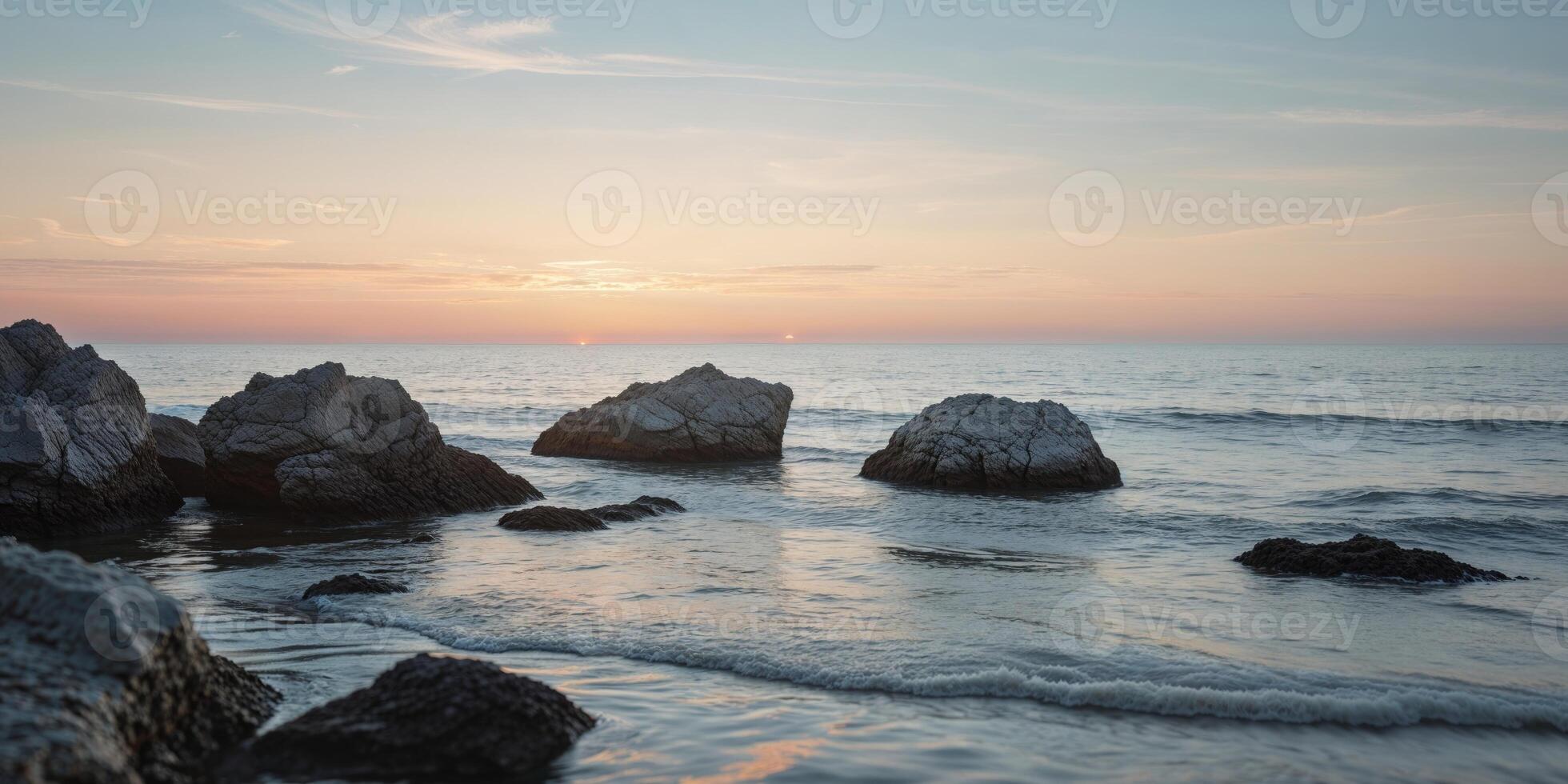 Rocks on the beach at sunset photo