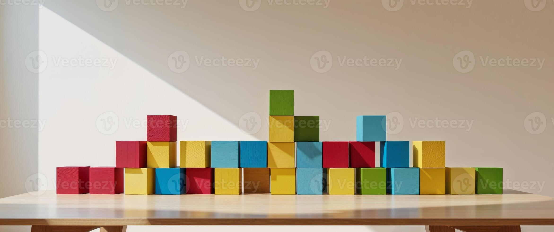 Colorful wooden blocks stacked on a table. photo