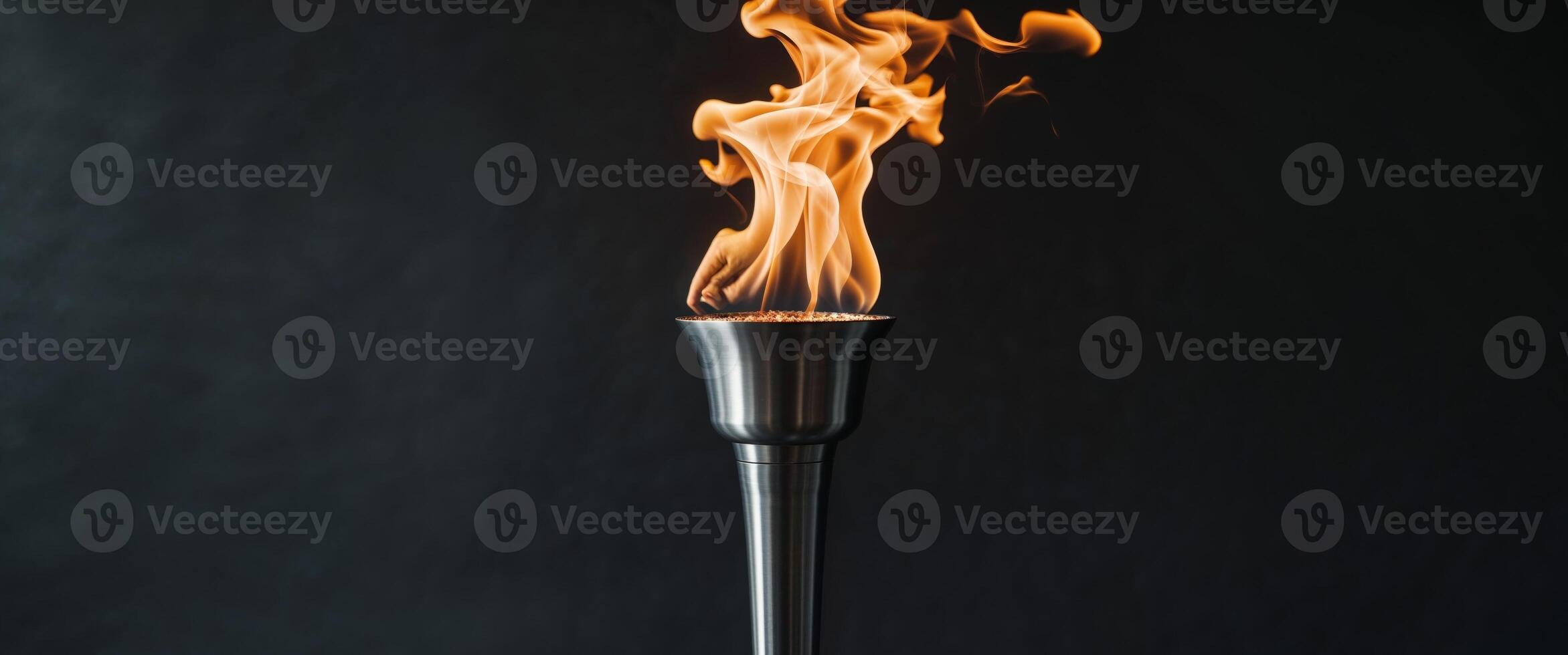 Beautiful torch with burning fire on black background photo
