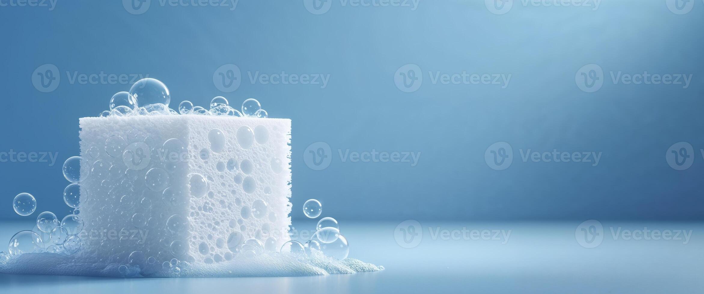 Clean sponge with soap bubbles on a blue background photo