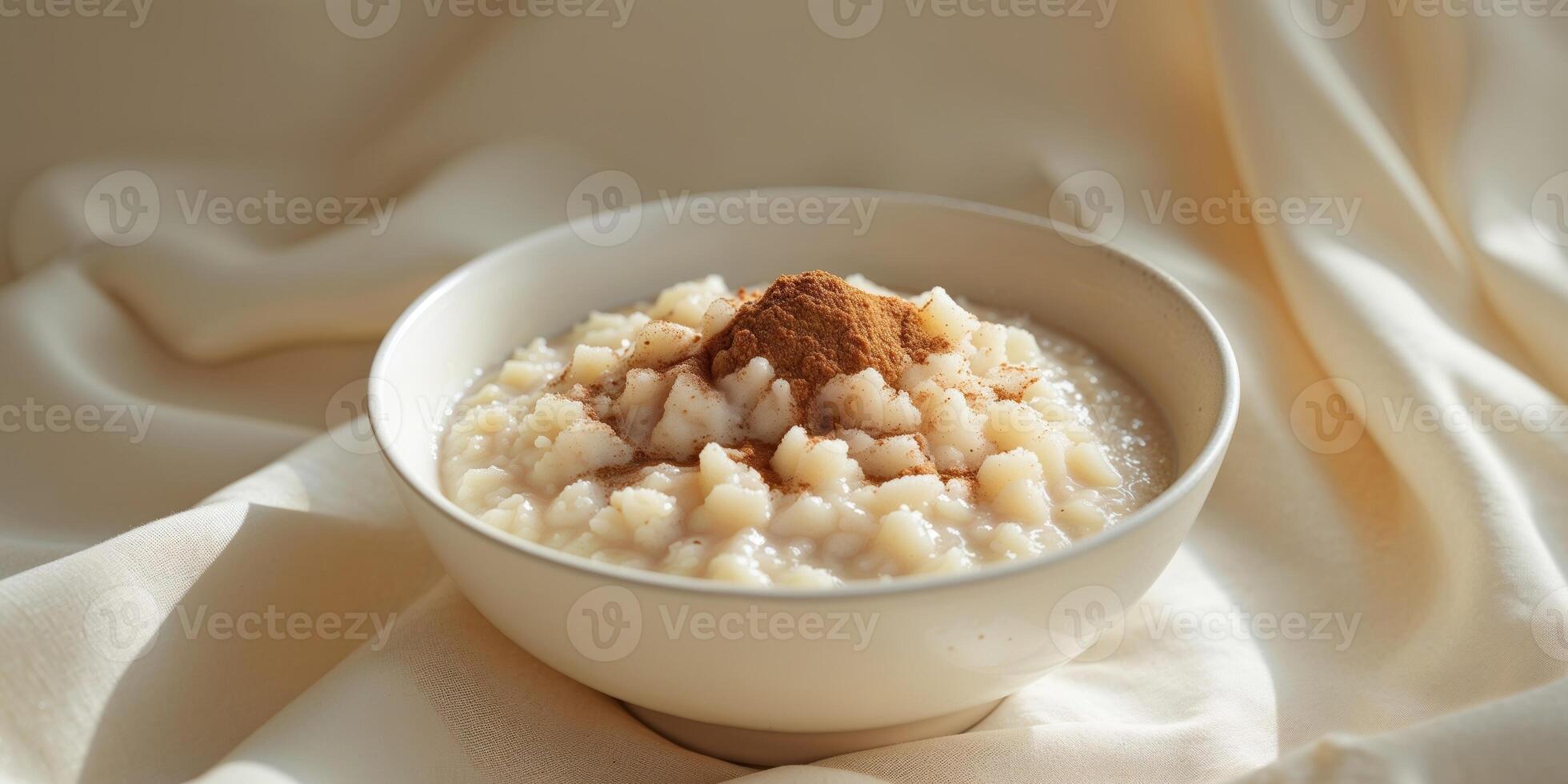 A bowl of sweet rice pudding with cinnamon on top photo