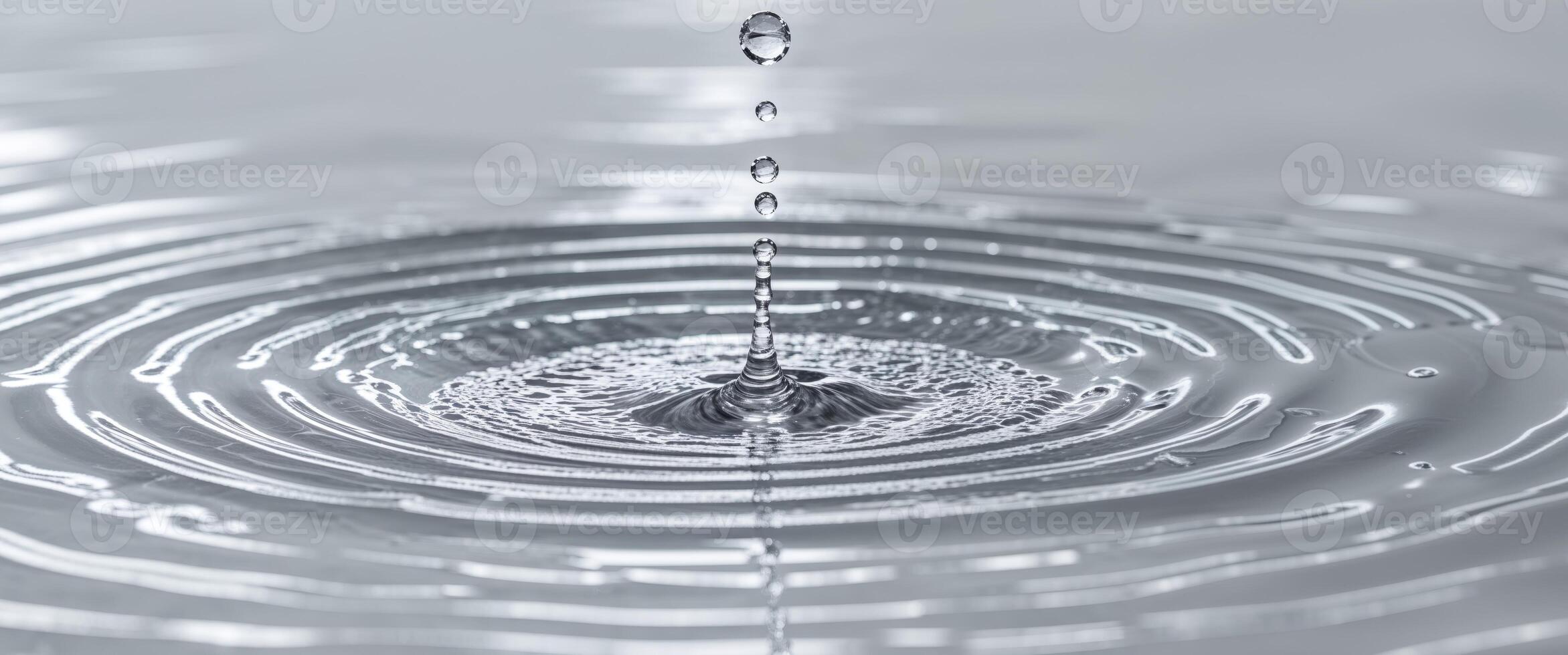 Water Droplet Impacting Still Water Creating Concentric Circles photo