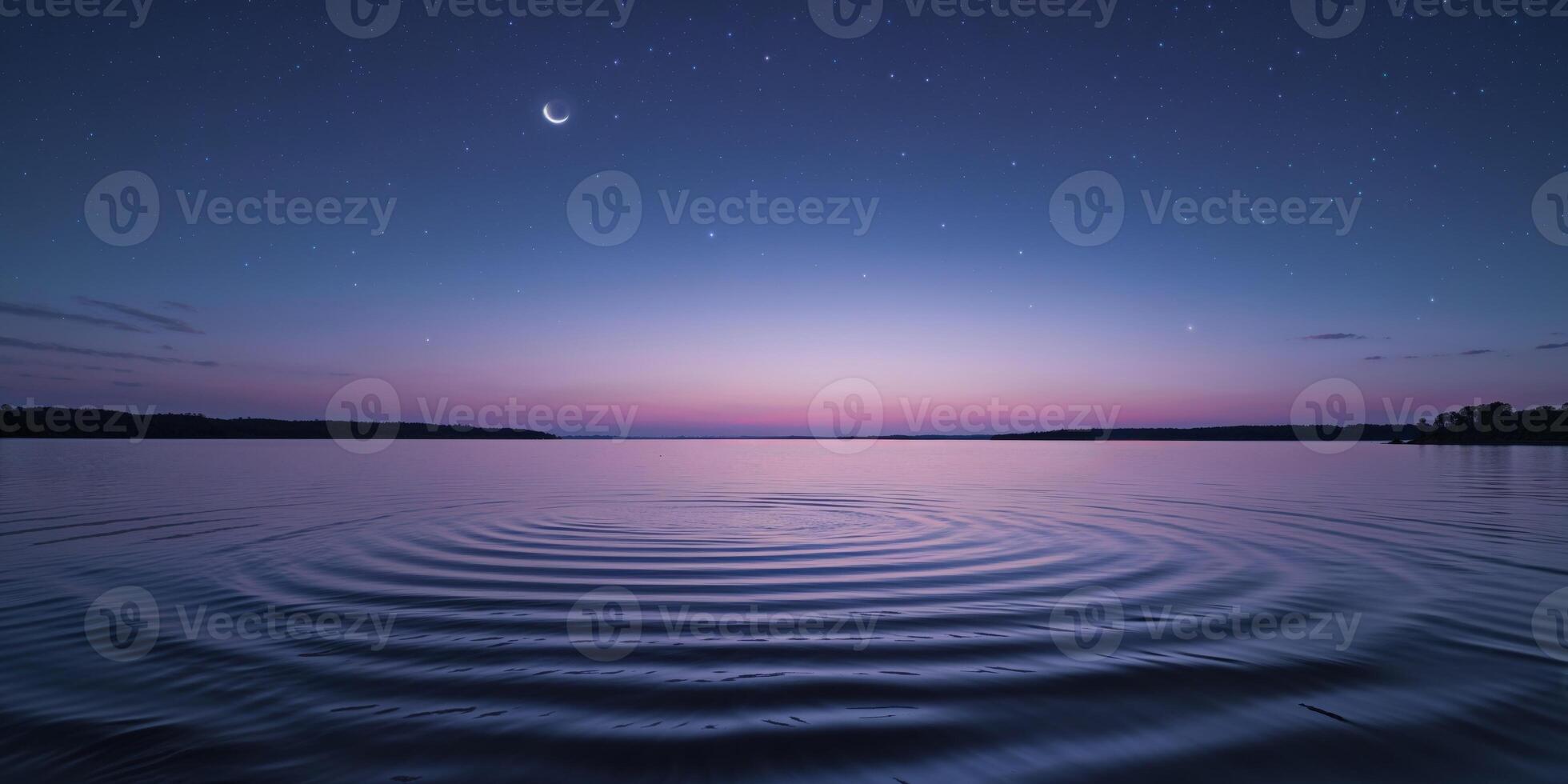 A moon and a ripple in the water at night photo