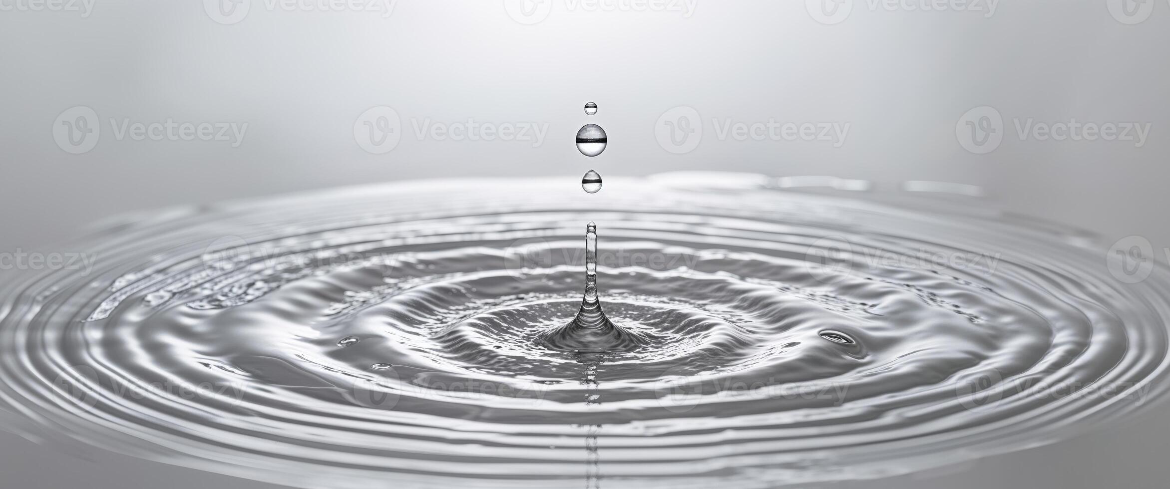 Water drop with ripple on a gray background photo