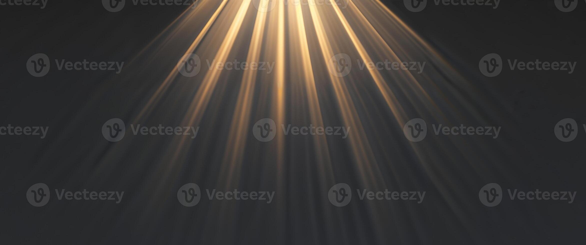 A light beam is shining down on a dark background photo