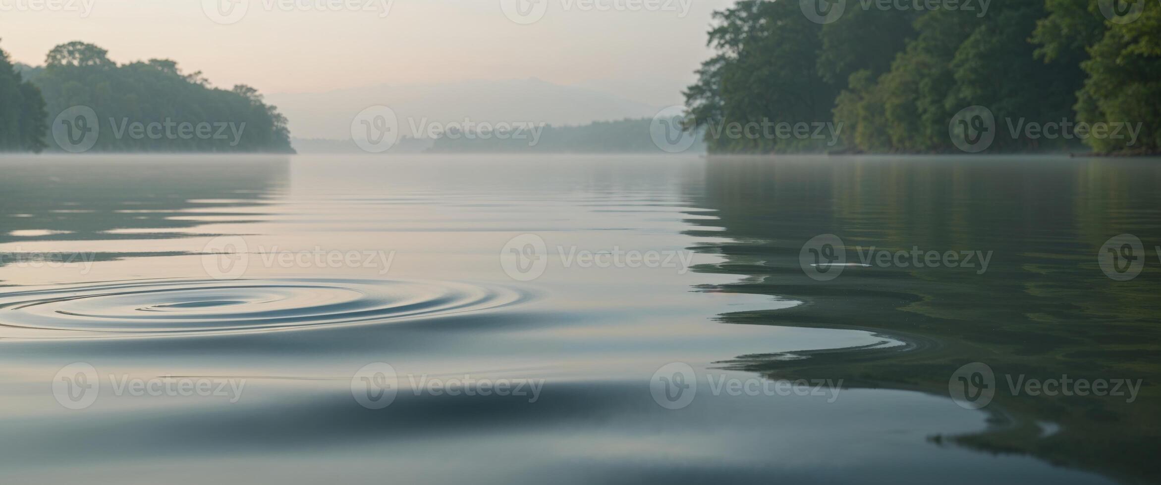A rippling lake with trees and water photo