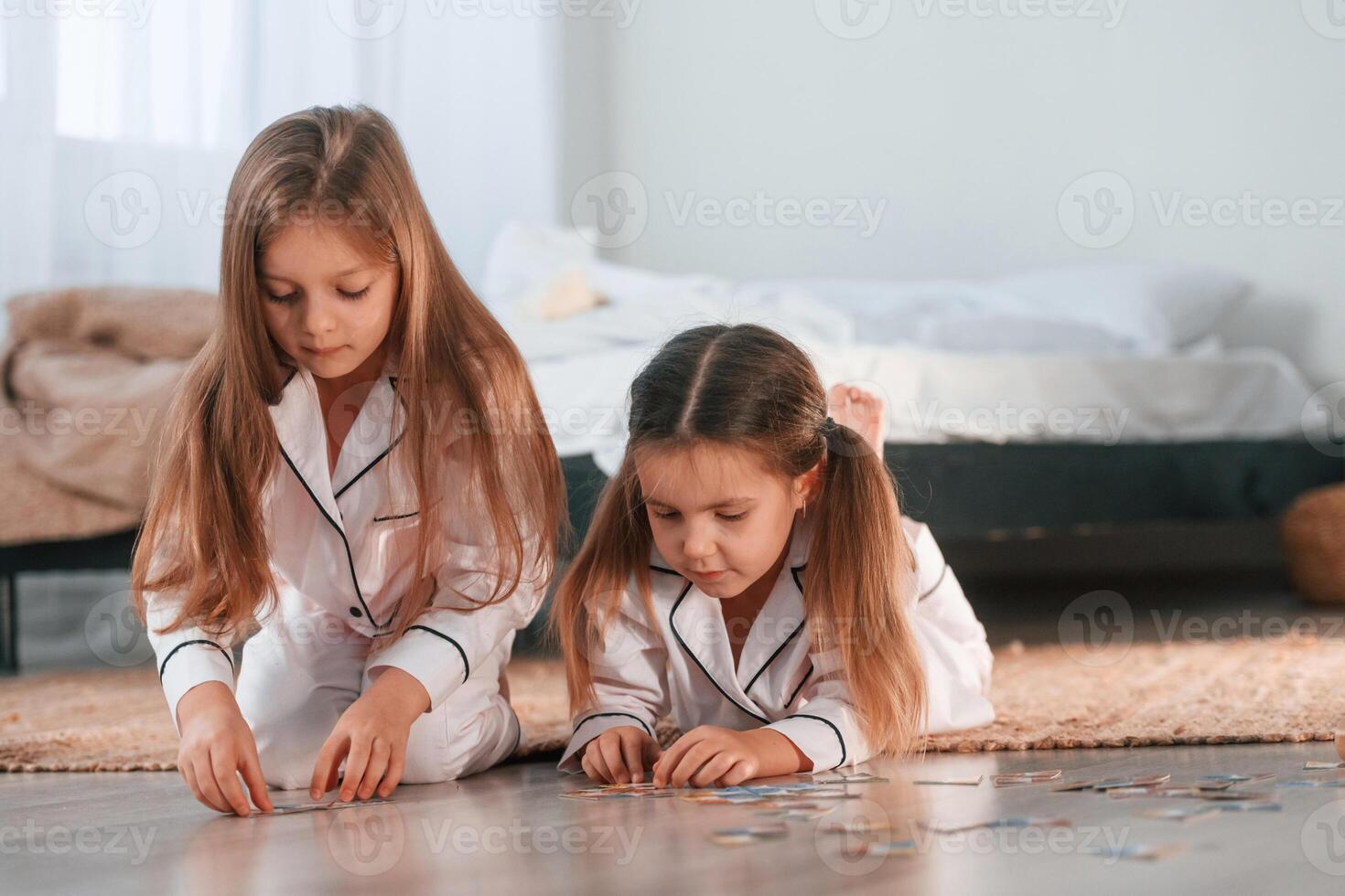 Playing card, game. Two, little girls are together in domestic room photo