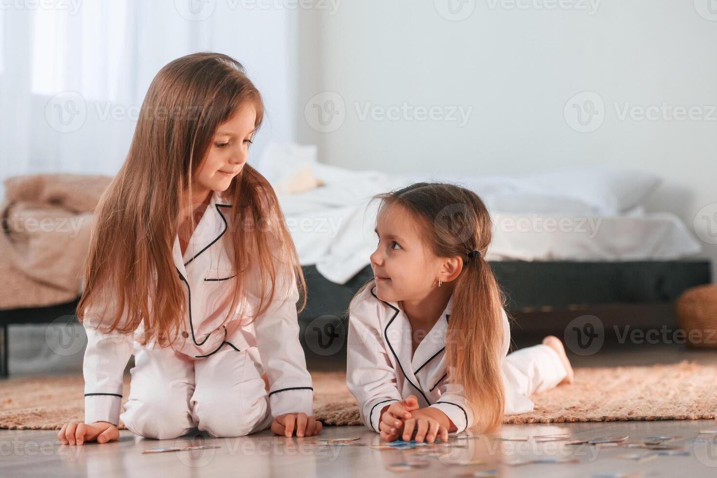 Playing card, game. Two little ,girls are together in domestic room photo