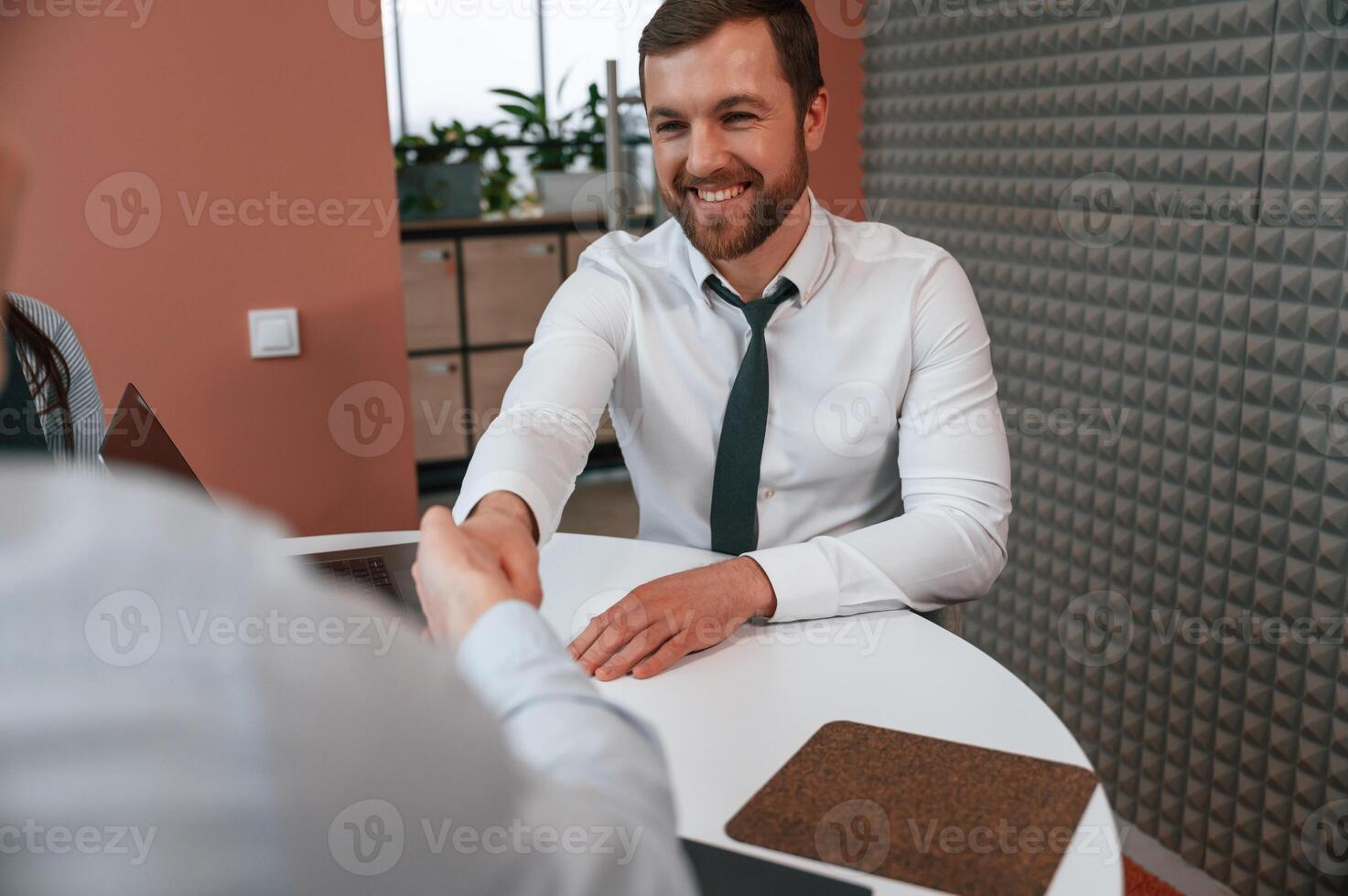 Making handshake, nice to meet ,you. Office workers are indoors by the table photo