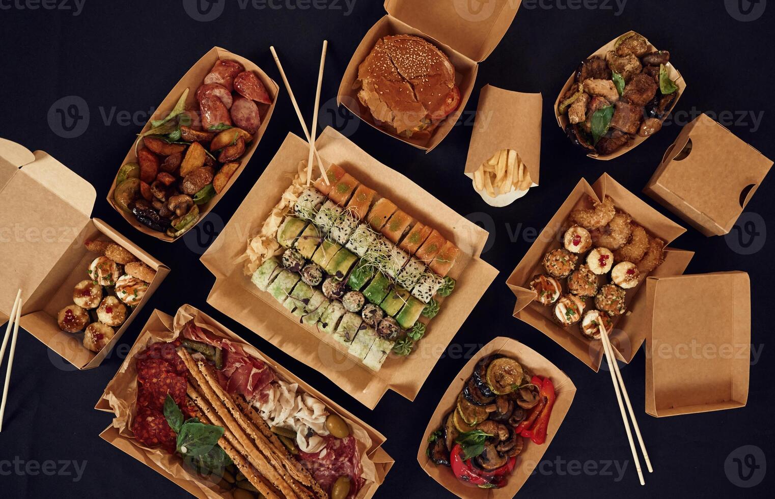 Top ,view of table with food on it. Meat,, vegetables, sushi, French fries, burger, mushrooms photo