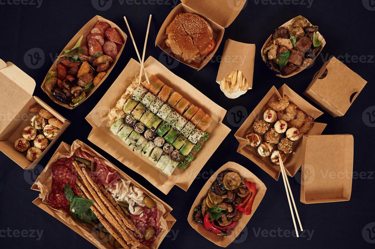 Top view of table with food on it. Meat, ,vegetables,, sushi, French fries, burger, mushrooms photo